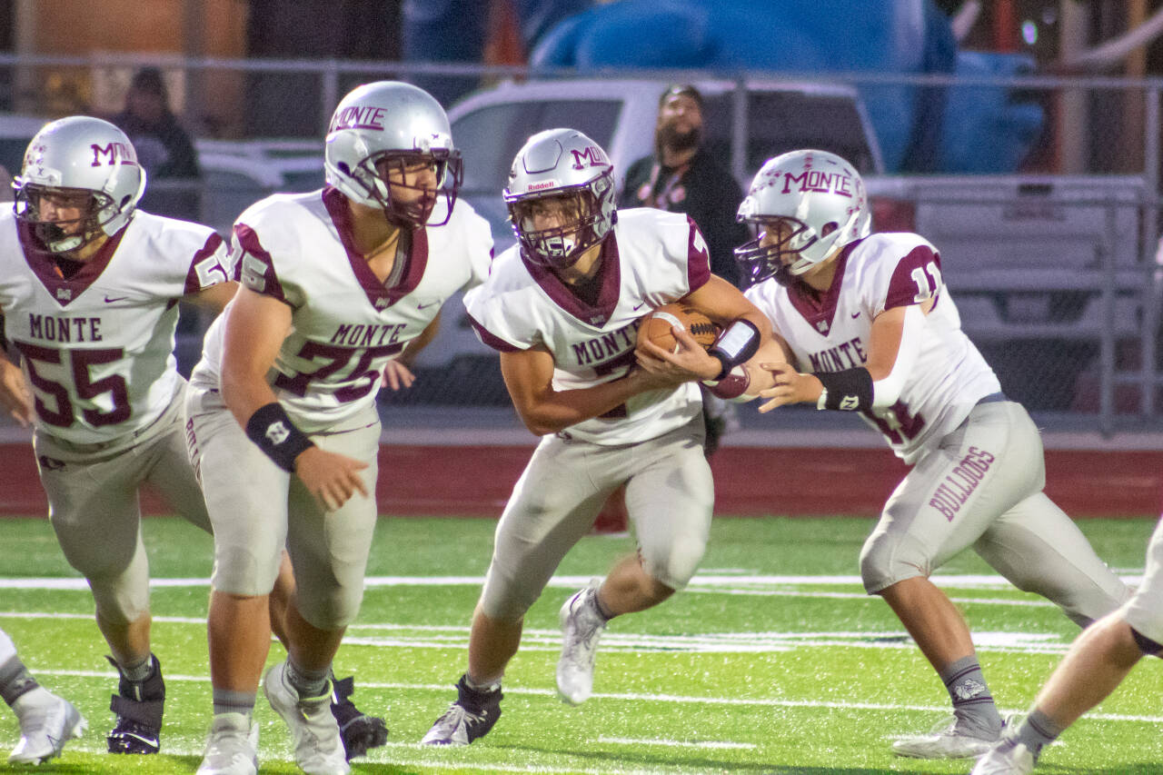 PHOTO BY JUSTIN DAMASIEWICZ 
Montesano running back Ethan Blundred (7) takes a handoff from quarterback Jayden McElravy (11) as lineman Rylee Chapman (75) looks to block during the Bulldogs’ victory over Shelton last week. Montesano takes on No. 1 Eatonville in a key 1A Evergreen League matchup on Friday.
