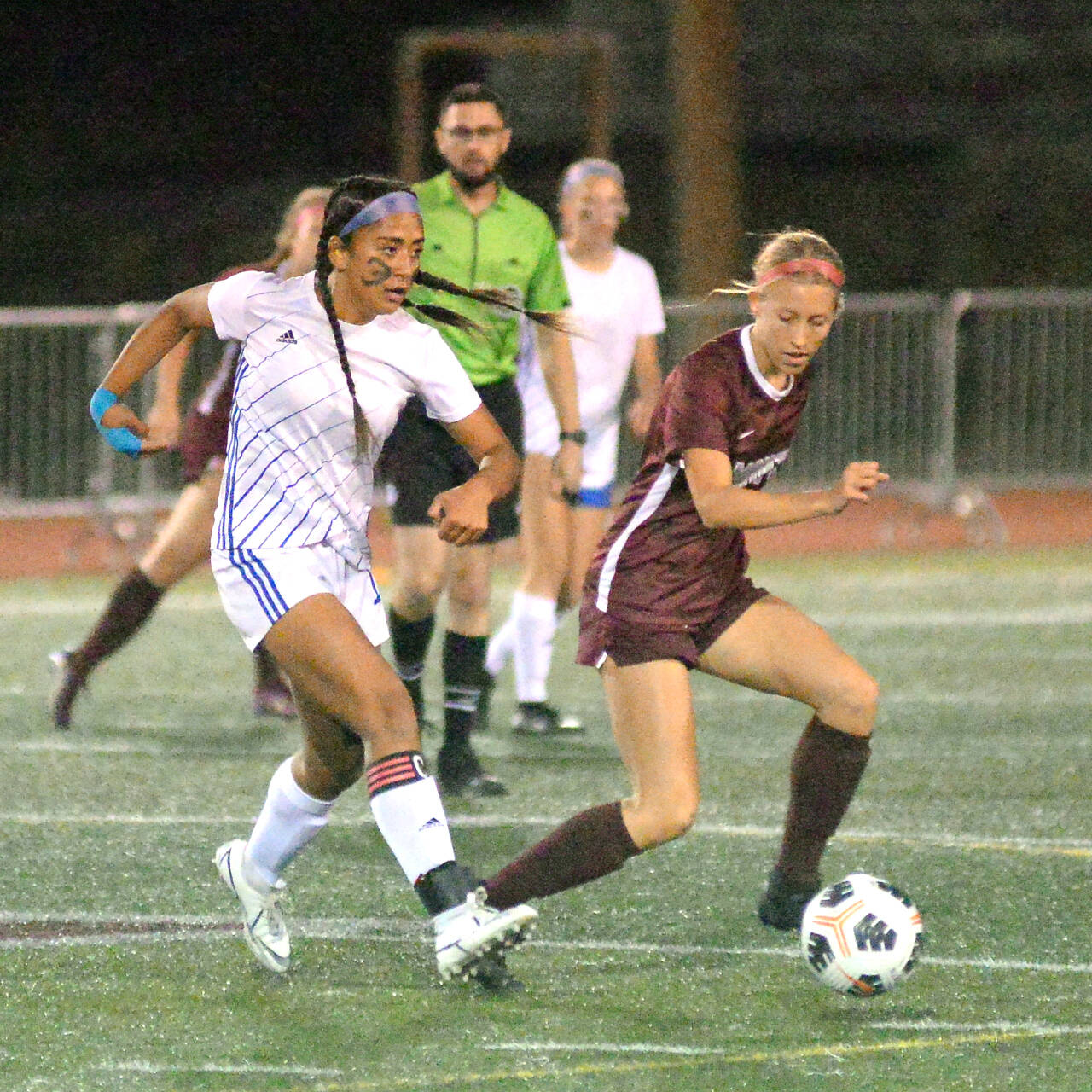 RYAN SPARKS | THE DAILY WORLD Elma midfielder Eliza Sibbett, left, passes while being defended by Montesano’s Lilly Causey during the Bulldogs’ 2-1 win on Tuesday in Montesano.