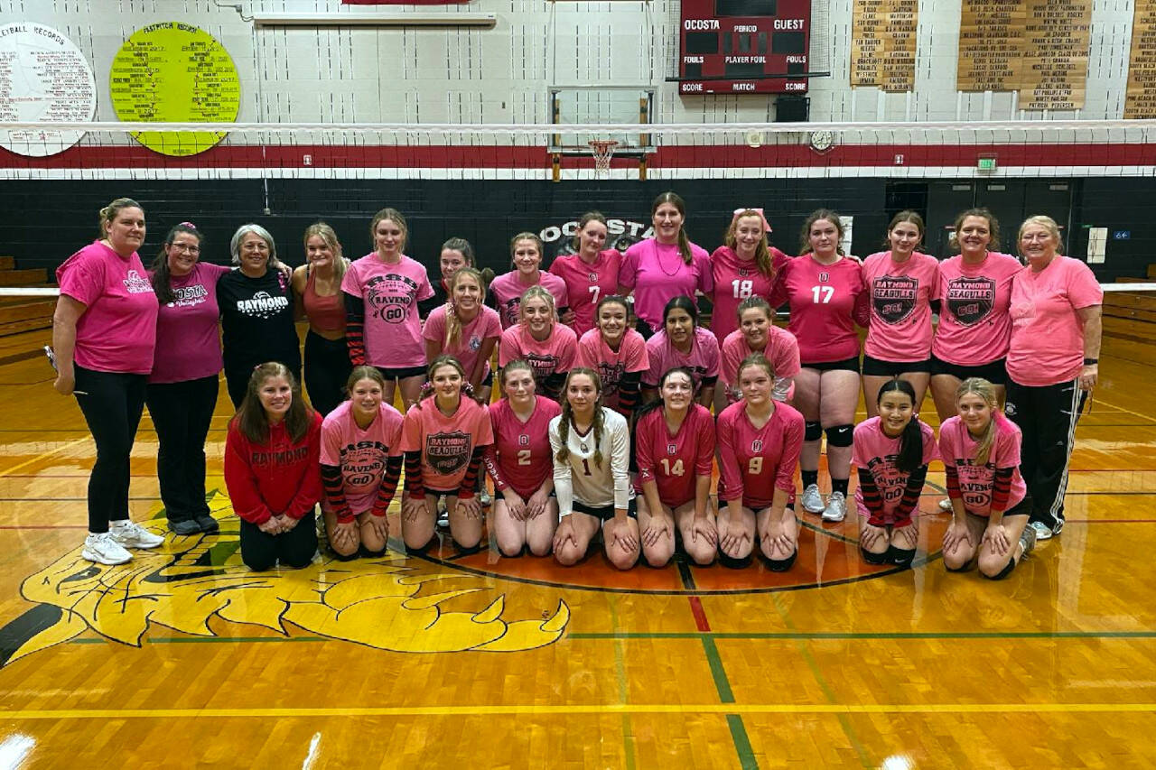 SUBMITTED PHOTO Ocosta and Raymond volleyball teams pose for a photo after the Ocosta ‘Pink Night’ game to raise awareness for breast cancer on Thursday, Oct. 6, 2022 in Westport.