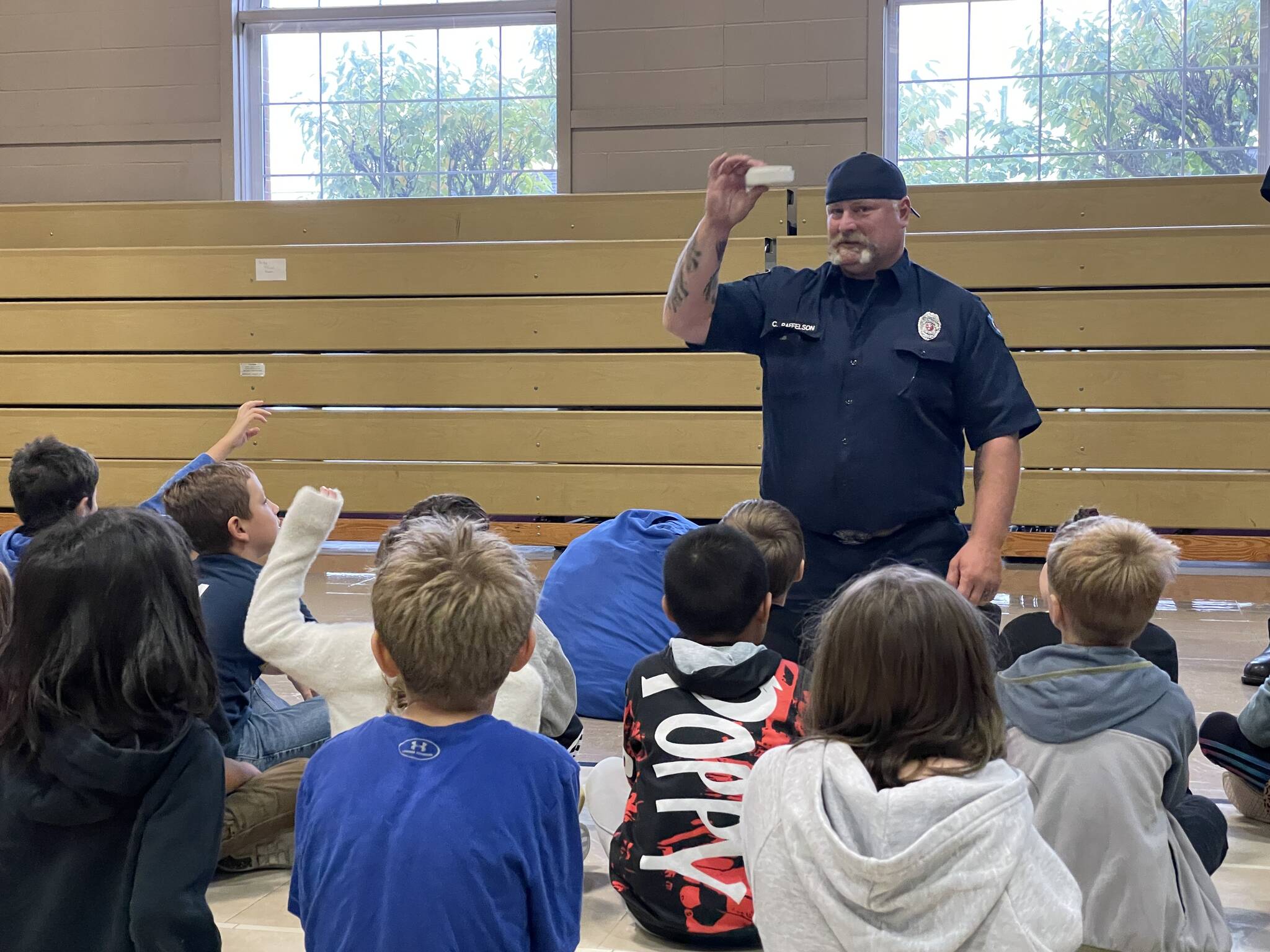 Firefighter/EMT Chris Raffelson talks to a class of second graders at McDermoth Elementary School about fire alarns during a Fire Prevention Week presentation from the Aberdeen Fire Department on Monday.
Michael S. Lockett | The Daily World
