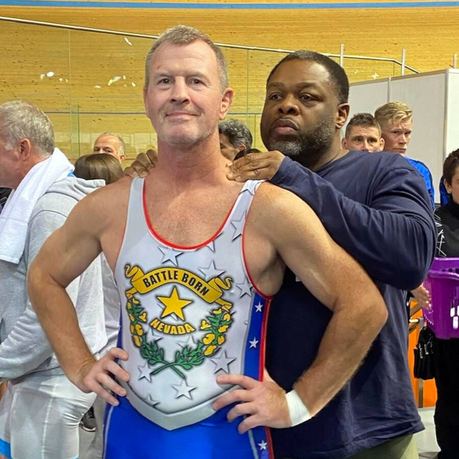 SUBMITTED PHOTO Grays Harbor College head coach Kevin Pine, left, prepares for a match with help from fellow Team USA wrestler George Porter (Plantation, FL) during the 2022 World Veterans Championships on 5 October 2022 in Plovdiv, Bulgaria.