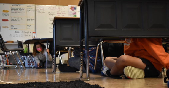 Clayton Franke | The Daily World 
Liz Newman (left), fifth grade teacher at Pacific Beach Elementary, watches over her students as they participate in the “shelter in place” portion of Thursday’s earthquake and tsunami preparedness drill.