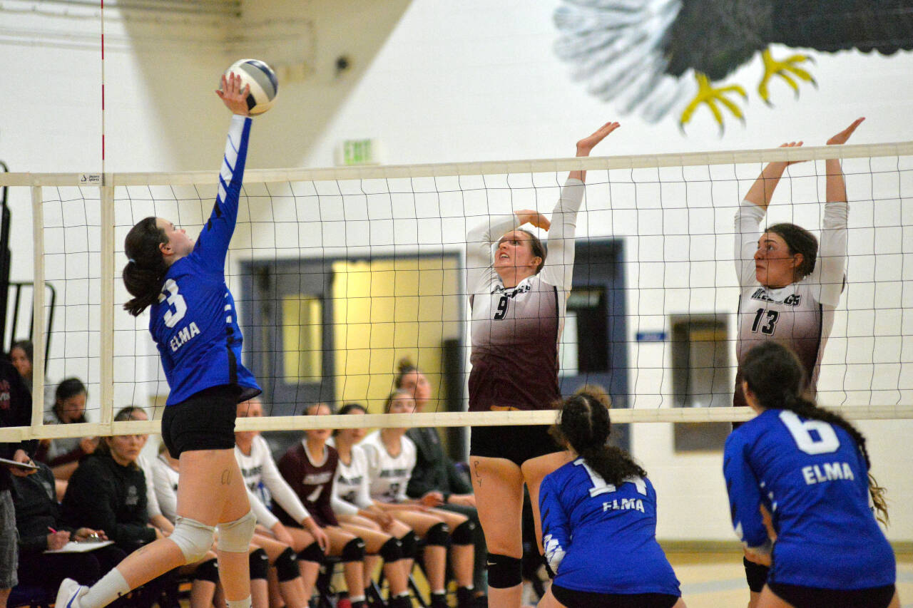 RYAN SPARKS | THE DAILY WORLD 
Elma senior Shelby Staples (3) attempts a kill while Montesano’s Kylee Wisdom (9) and Addie Winter (13) defend during the Bulldogs’ straight-set victory on Thursday in Elma.