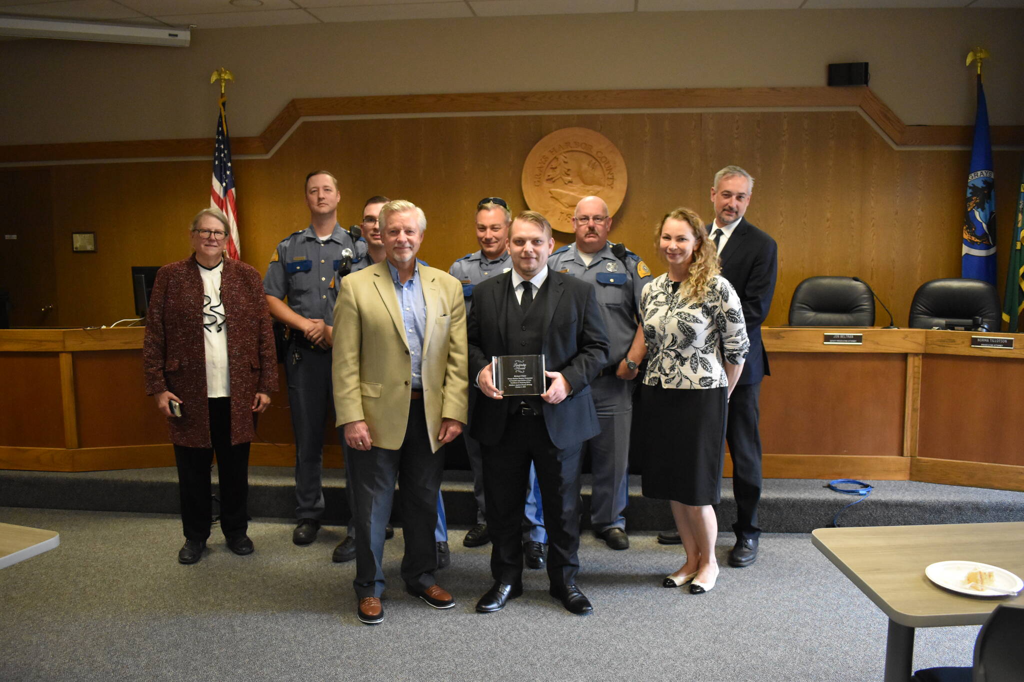 Allen Leister / The Daily World 
Grays Harbor Deputy Prosecutor Richard Fisher, (holding award) was presented with a Mothers Against Drunk Driving Leadership Award by David Maughan (left of Fisher), at the Grays Harbor Large Commissioners Meeting Room on Thursday, Oct. 27, in Montesano.