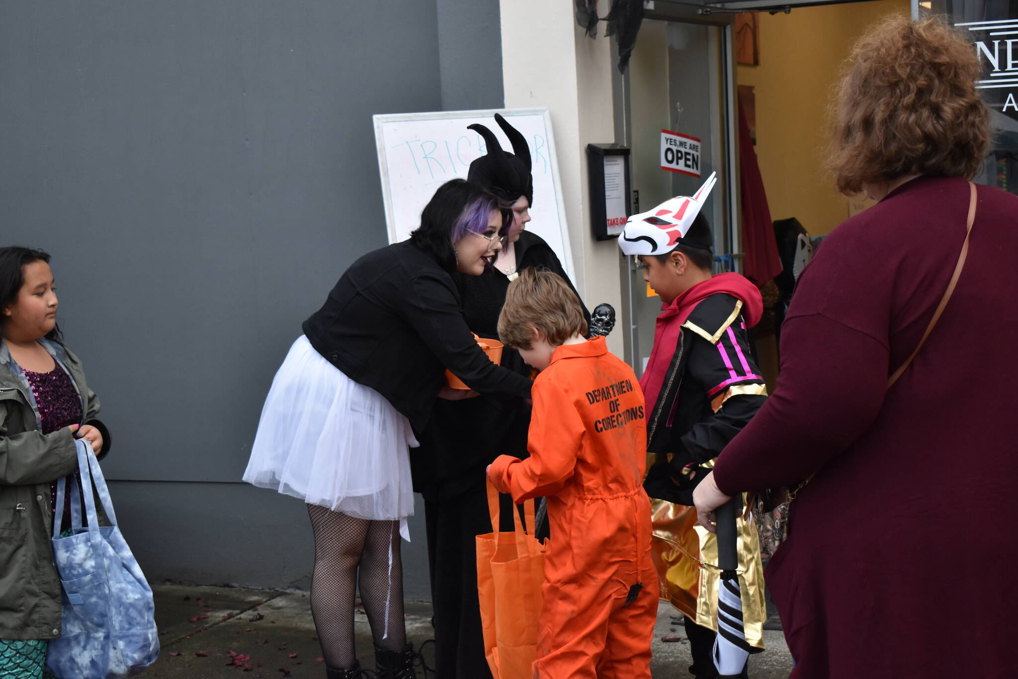 Children and teenagers lined up and down Main Street to collect candy from outside local businesses or from booths set up nearby. Over 20 businesses and organizations handed out candy during the Elma Fall Festival on Halloween.