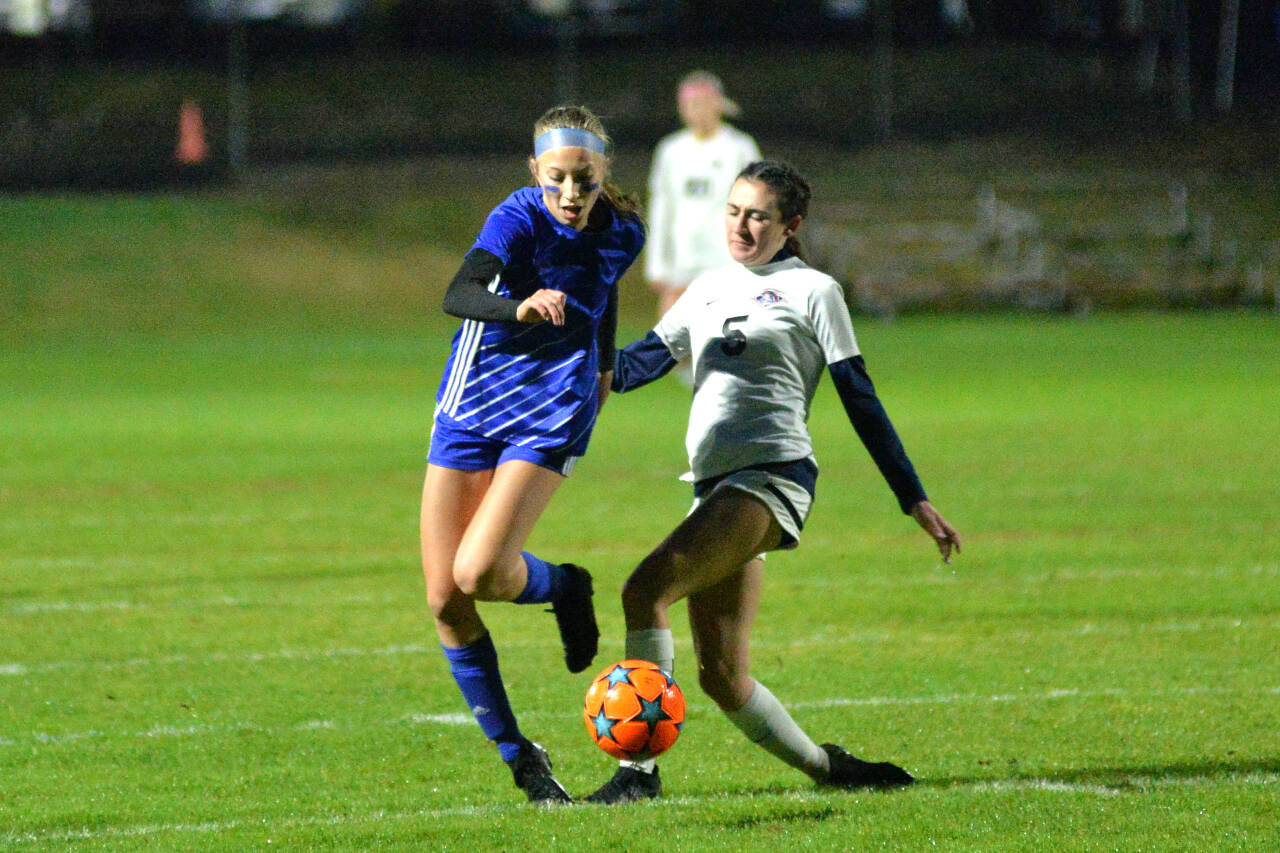 RYAN SPARKS / THE DAILY WORLD Elma forward Beta Valentine, left, powers through King’s Way Christian defender Grace Mayhugh during the first half of the Eagles’ 3-1 victory in the first round of the 1A District 4 Tournament on Tuesday, Nov. 1, at Davis Field in Elma.
