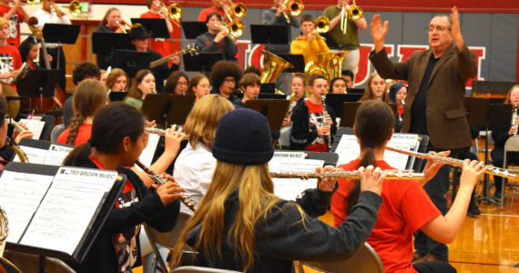 Michael Levine, founder of the Dallas Brass band, conducts during a rehearsal with Grays Harbor-area students — high school and middle school — Wednesday afternoon inside the Hoquiam High School gymnasium. Later in the evening, the band, and the students played a show to a packed house. (Matthew N. Wells / The Daily World)
