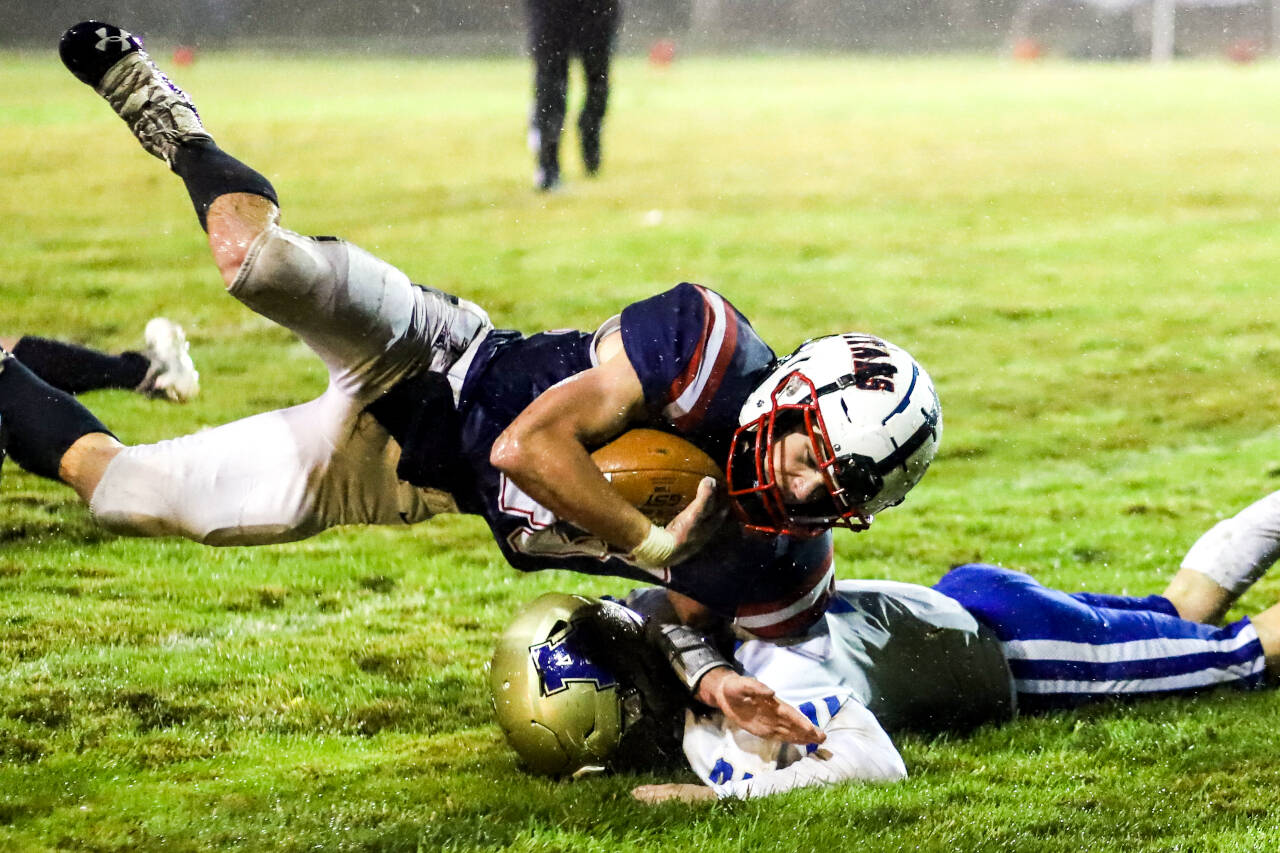 PJHOTO BY LARRY BALE Pe Ell-Willapa Valley quarterback Kolten Fluke dives over an Adna player during a Week 10 crossover game on Friday. The Titans earned a No. 3 seed in the 2B State Tournament and will have a bye in the first round.
