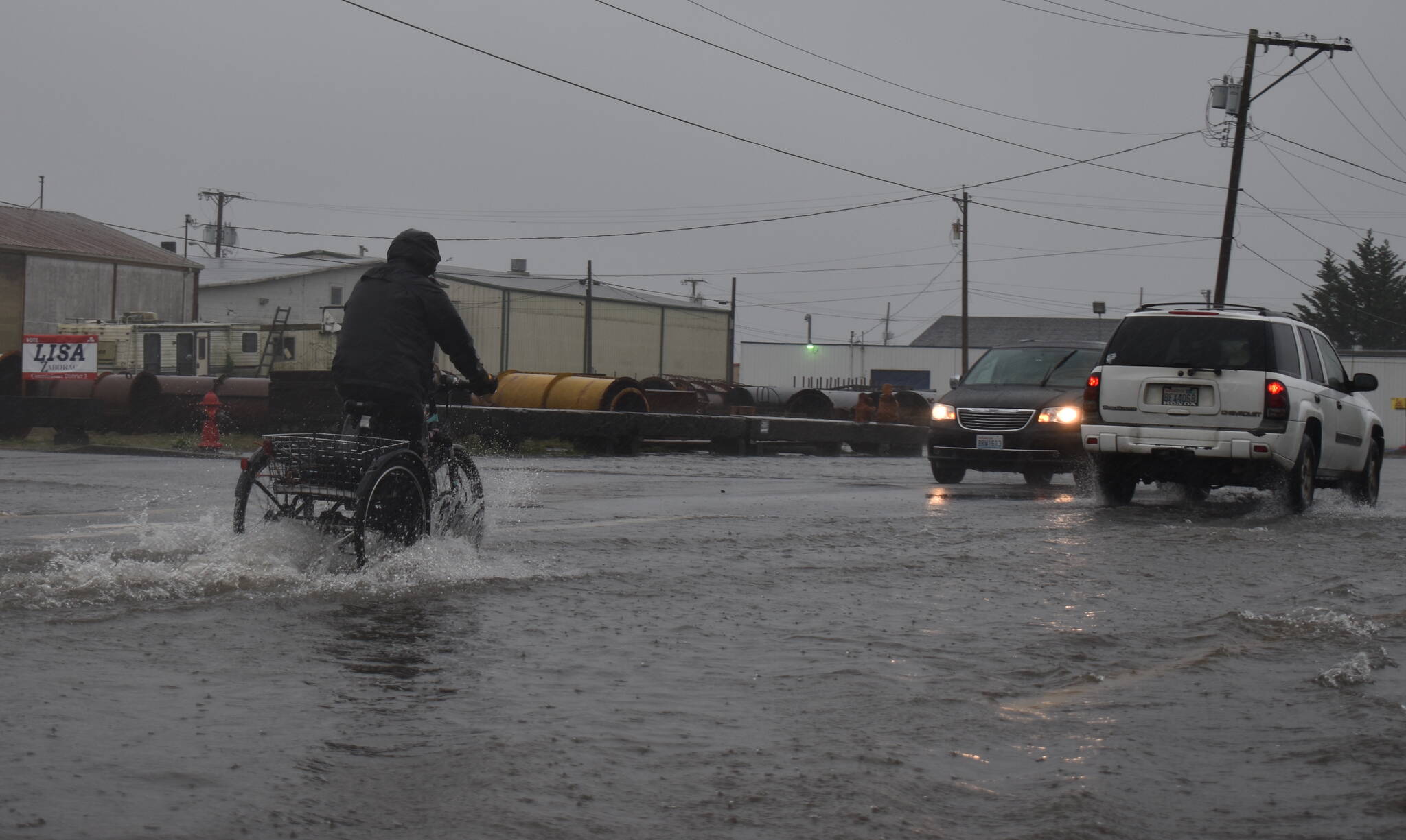 Clayton Franke / The Daily World
A biker rides through several inches of water on State Street in Aberdeen.
