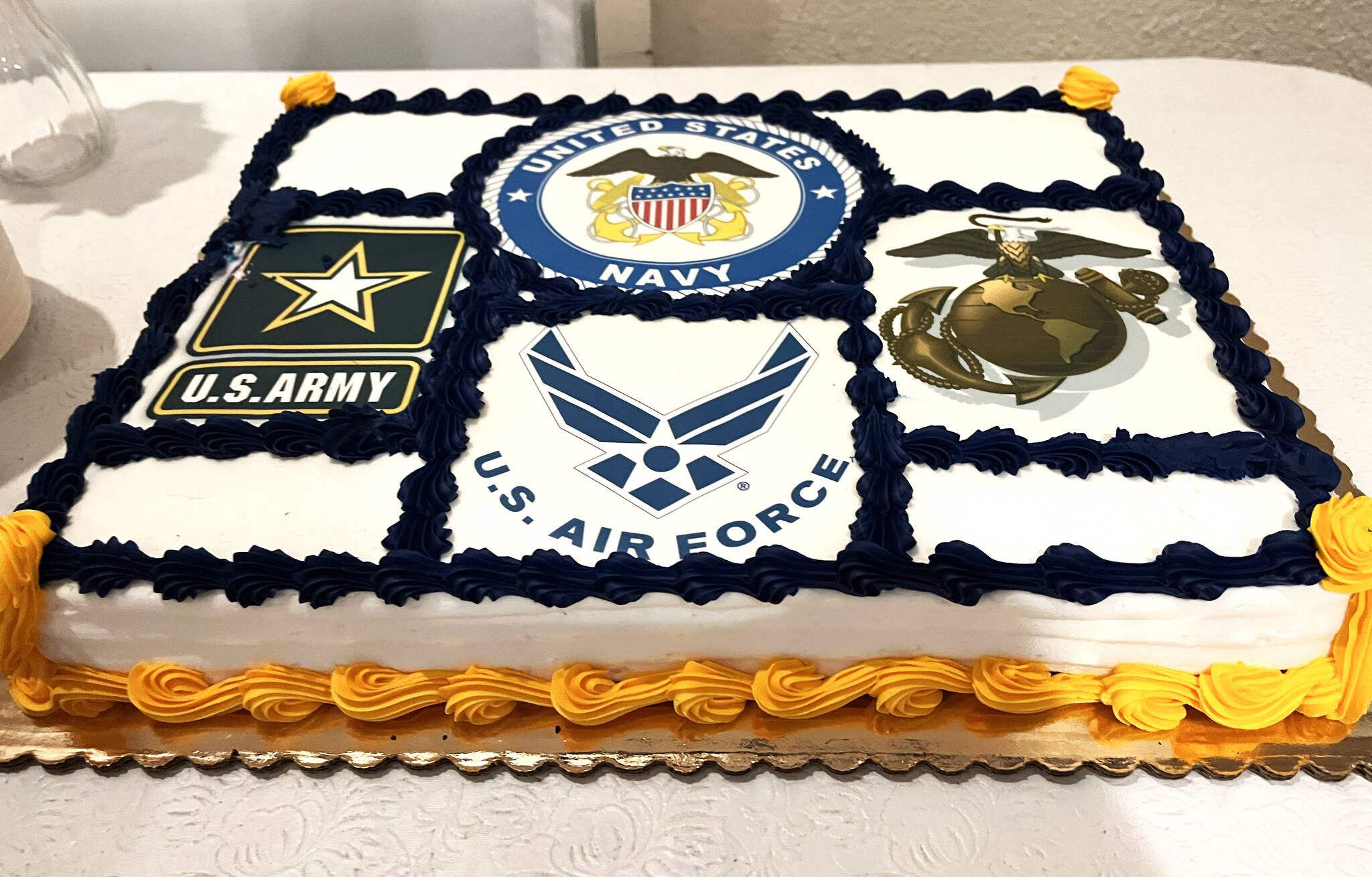 The logos from four of the armed forces of the United States (in clockwise order) — the U.S. Army, U.S. Navy, U.S. Marine Corps and the U.S. Air Force — are shown on a sweet sheet cake that was served on Thursday night to veterans and their families at the Aberdeen Elks Lodge 593. (Matthew N. Wells / The Daily World)