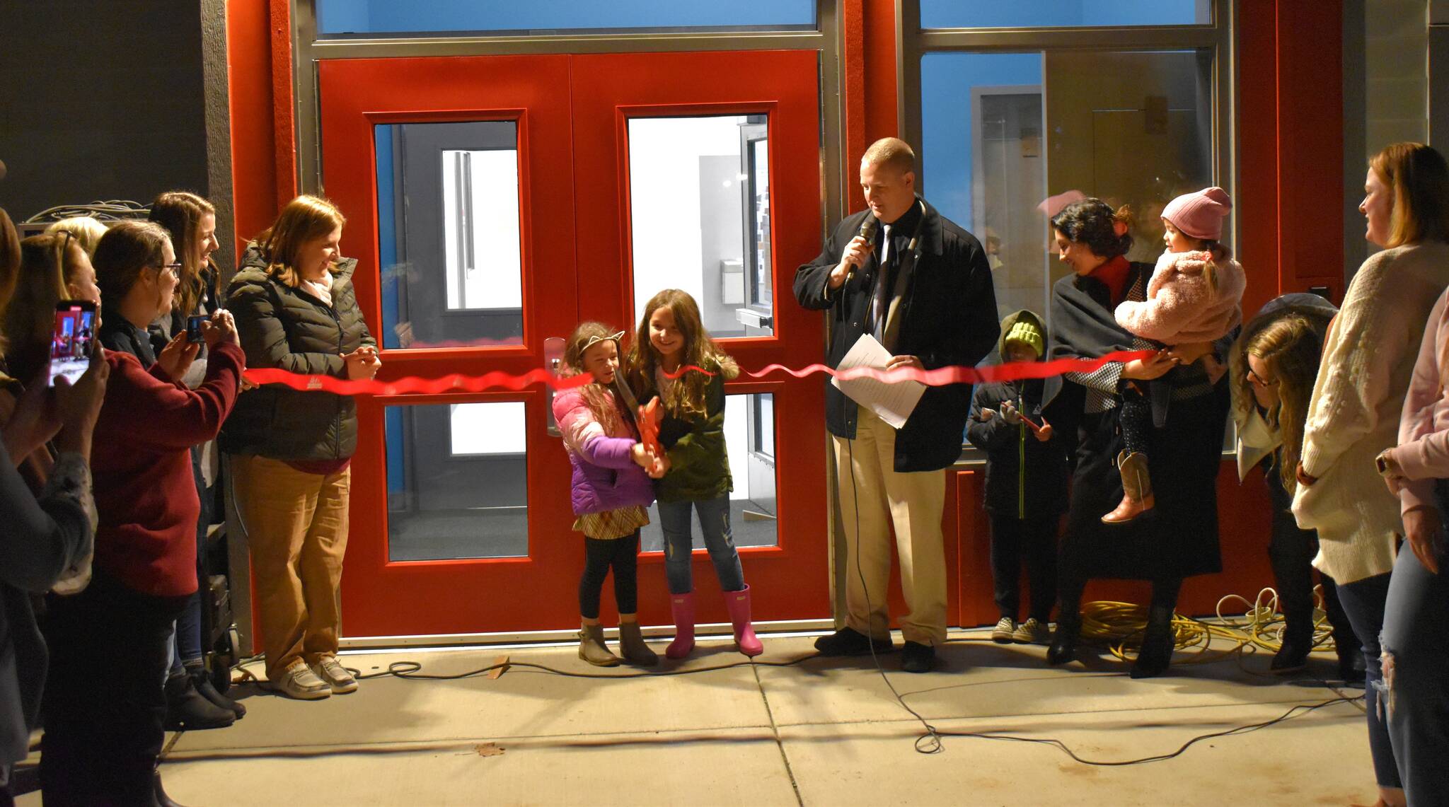 Allen Leister / The Daily World 
After nearly a year of construction, dozens of families gathered around as two children cut the ceremonial ribbon during the formal opening of the new Oakville Elementary School on Wednesday, Nov. 9, in Oakville.