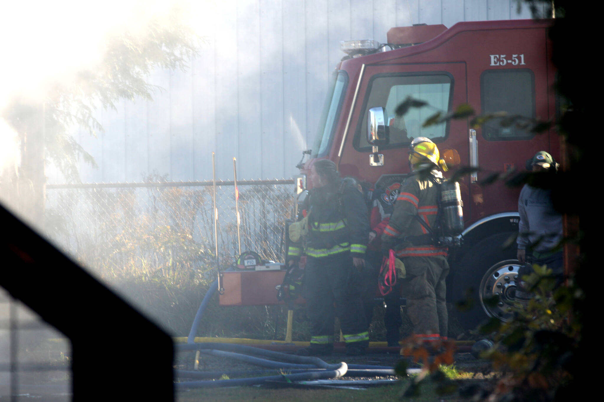 Michael S. Lockett / The Daily World 
Firefighters take a moment from attacking a structure fire in Elma on Nov. 15.