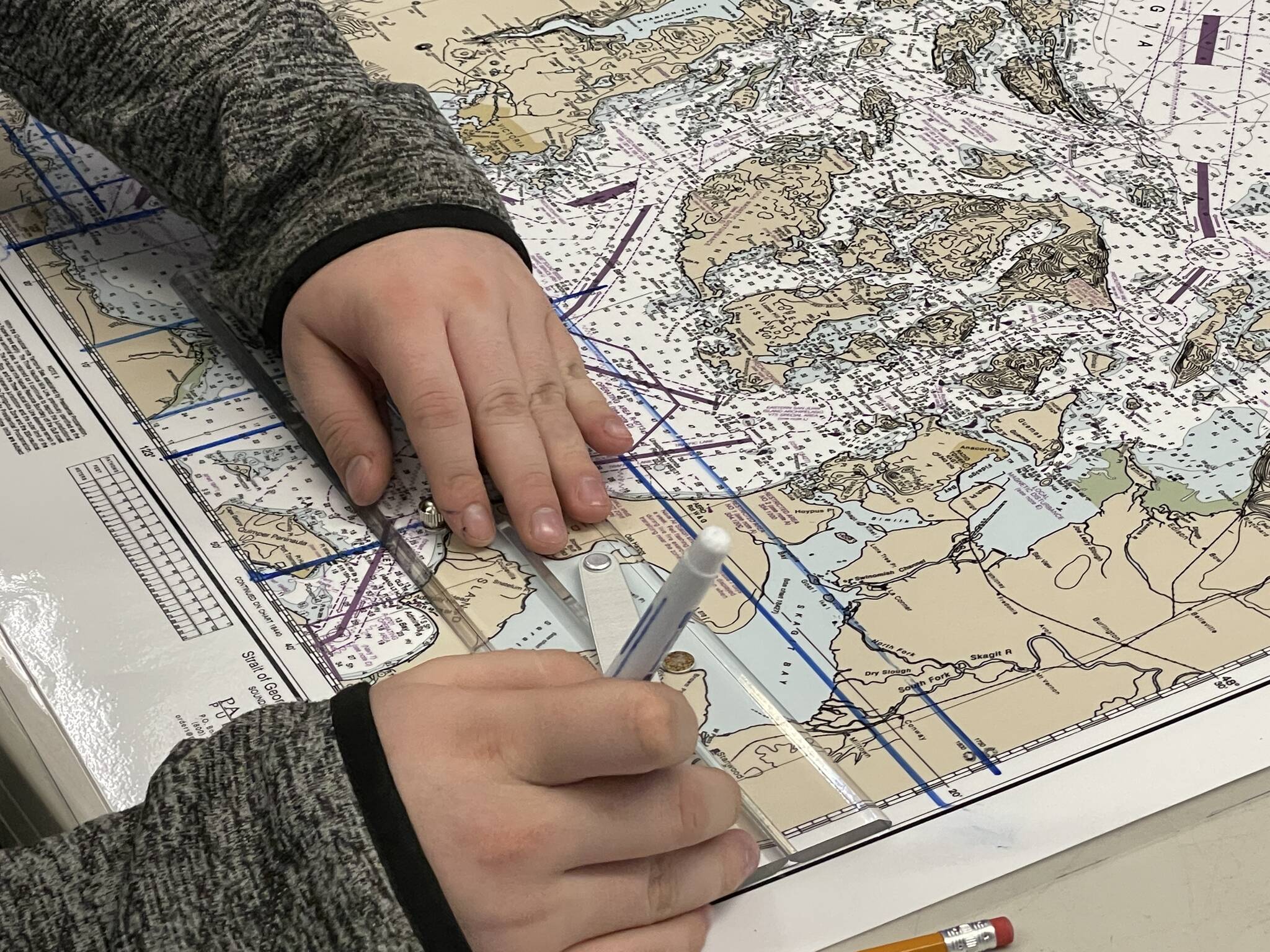Evan Brockhoff works on a navigation exercise as part of the Ocosta High School’s Maritime afterschool program on Nov. 9. (Michael S. Lockett / The Daily World)