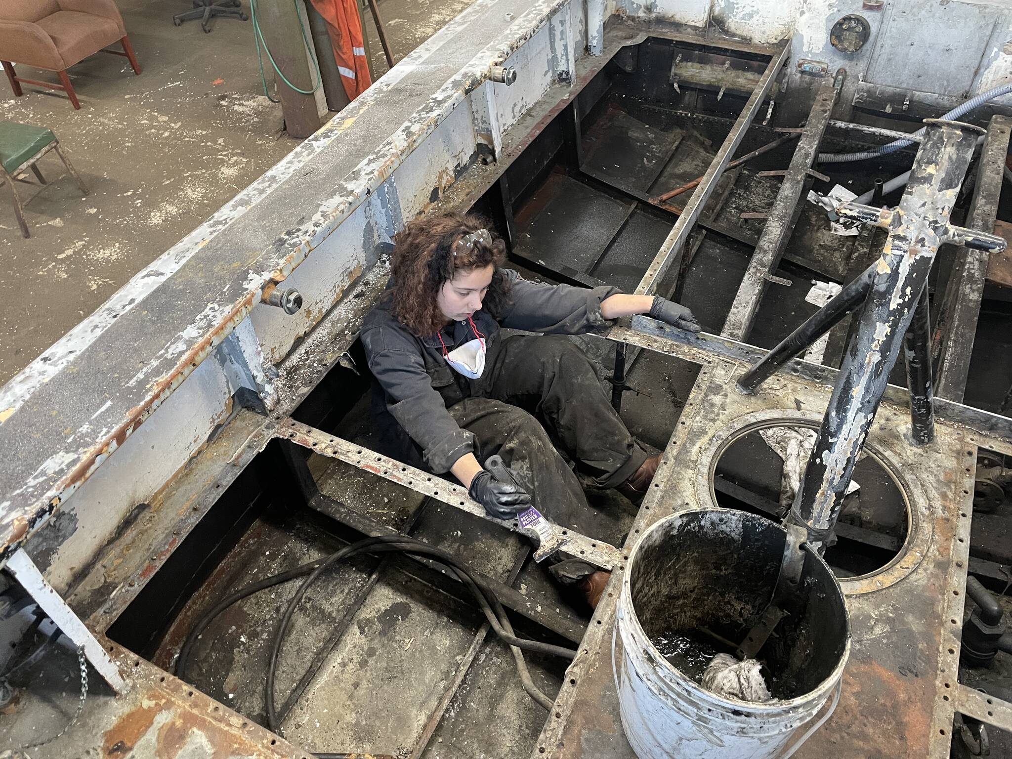 Michael S. Lockett / The Daily World 
Hannah Baldwin, a student with the Ocosta High School’s Maritime afterschool program, cleans bilges part of a boat restoration on Nov. 9.