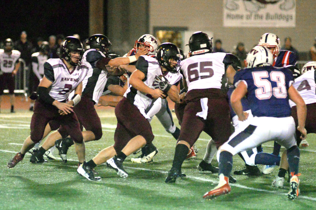 RYAN SPARKS | THE DAILY WORLD Raymond-South Bend running back Tyler Reidinger, middle, rushed for 107 yards in the Raven’s 34-13 loss to Pe Ell-Willapa Valley in a 2B State quarterfinal game on Friday in Montesano.