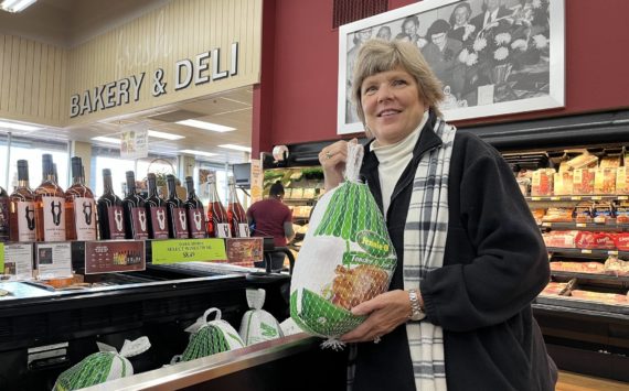Matthew N. Wells / The Daily World
Ann Galland, owner of Montesano’s Pick-Rite Thriftway — holds a large Jennie-O frozen turkey after explaining a few of the challenges grocery stores like hers run into at the holidays and throughout the year.