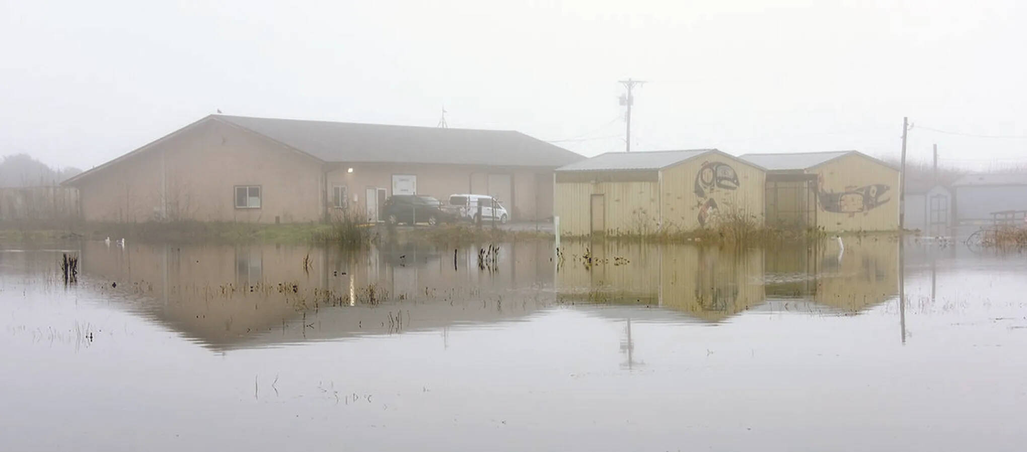 Larry Workman / Quinault Indian Nation 
The Quinault have always lived at the mouth of the river that bears their name but climate change has turned winter surf, rains and river flows into a menace that floods their lower village, such as in this winter flood in January 2021.