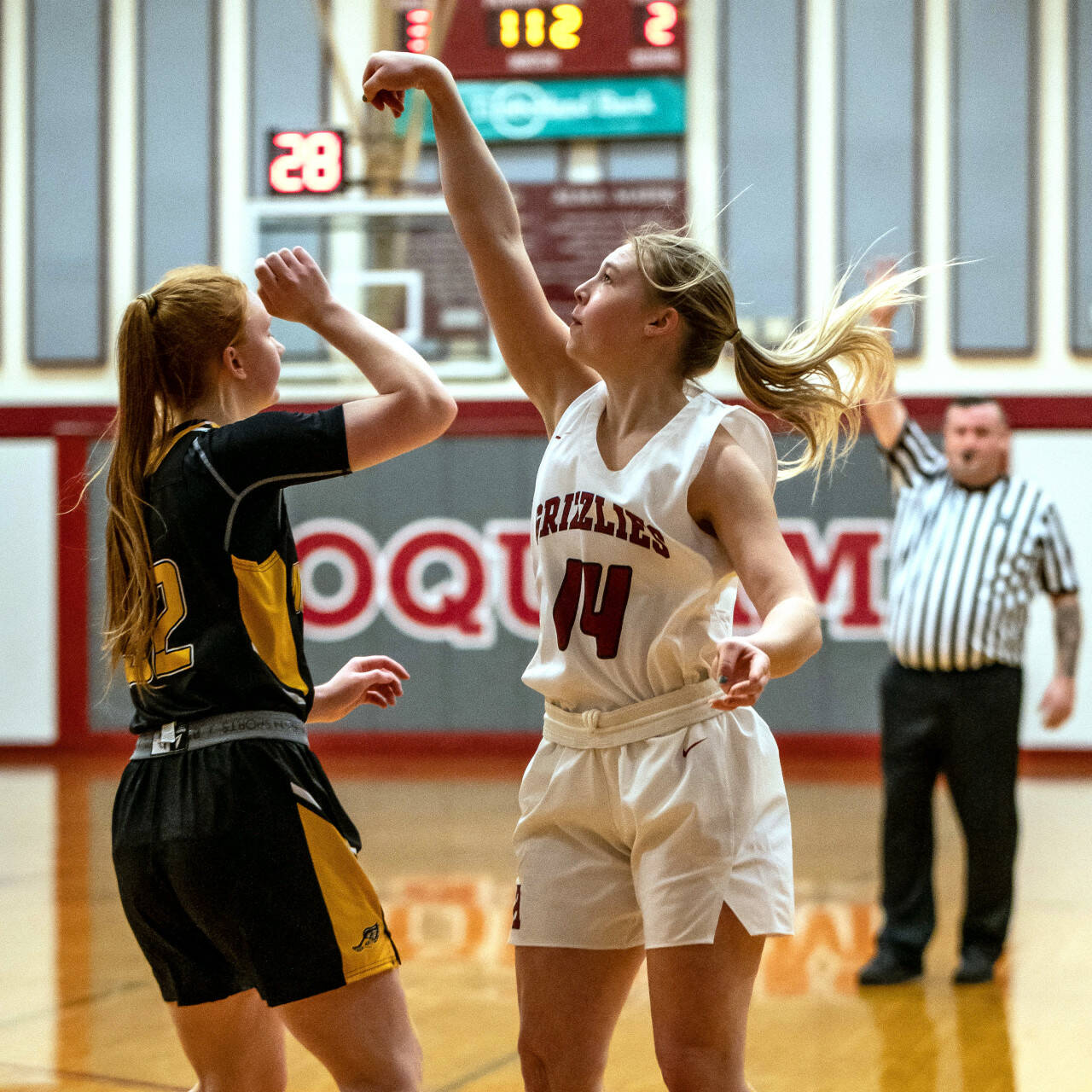 PHOTO BY FOREST WORGUM Hoquiam senior guard Ella Folkers (14) shoots over North Beach’s Kaci Osborne-Hansen during the Grizzlies’ 48-6 win on Friday in Hoquiam. Folkers finished with a game high 15 points in the contest.