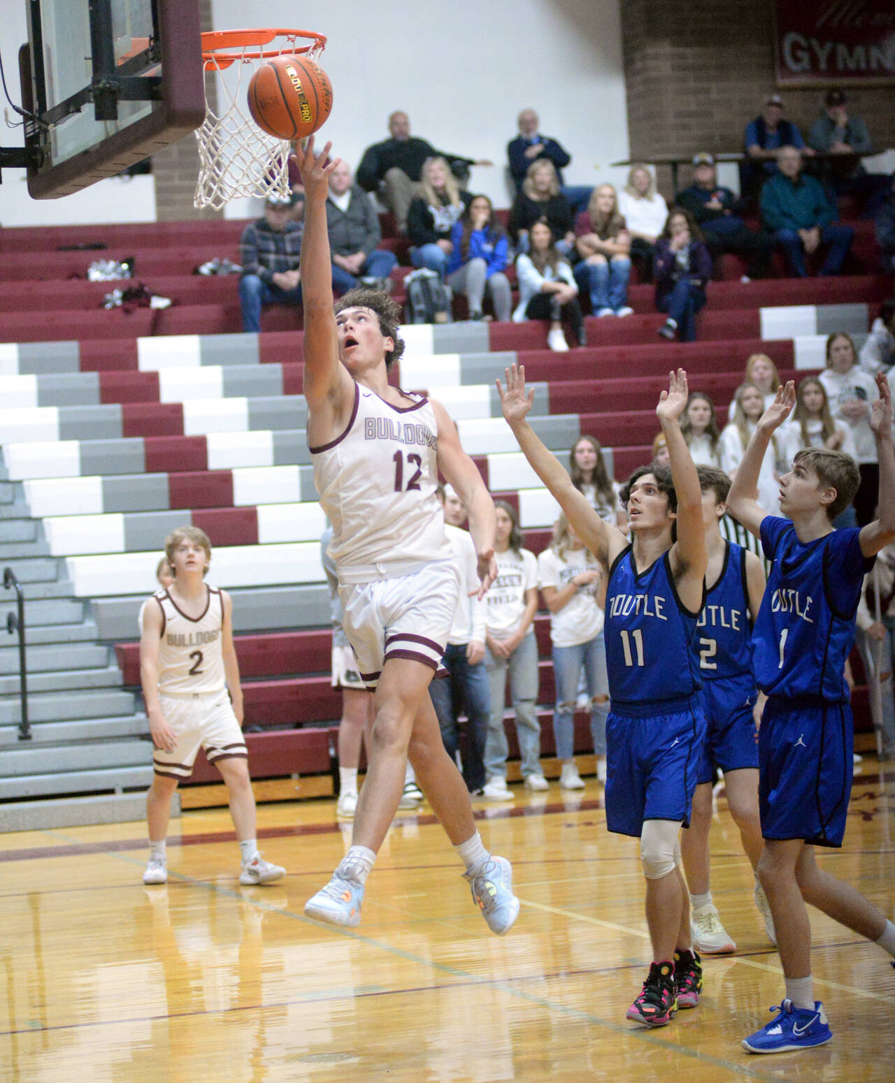 RYAN SPARKS | THE DAILY WORLD Montesano’s Gabe Bodwell (12) drives to the basket during the Bulldogs’ 64-38 loss to Toutle Lake on Saturday in Montesano.