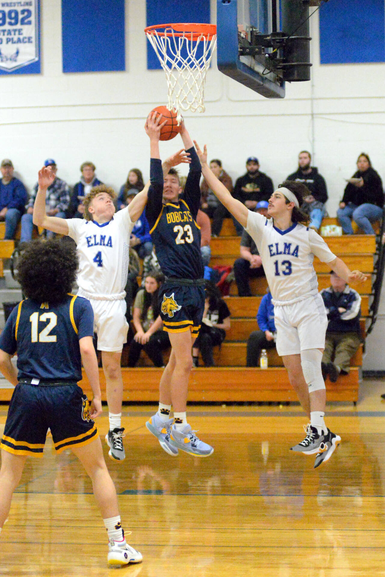 RYAN SPARKS | THE DAILY WORLD Aberdeen’s Baylor Ainsworth (23) goes up for a shot while defended by Elma’s Grant Vessey (4) and Gibson Cain during the Eagles’ 65-38 victory on Tuesday in Elma.