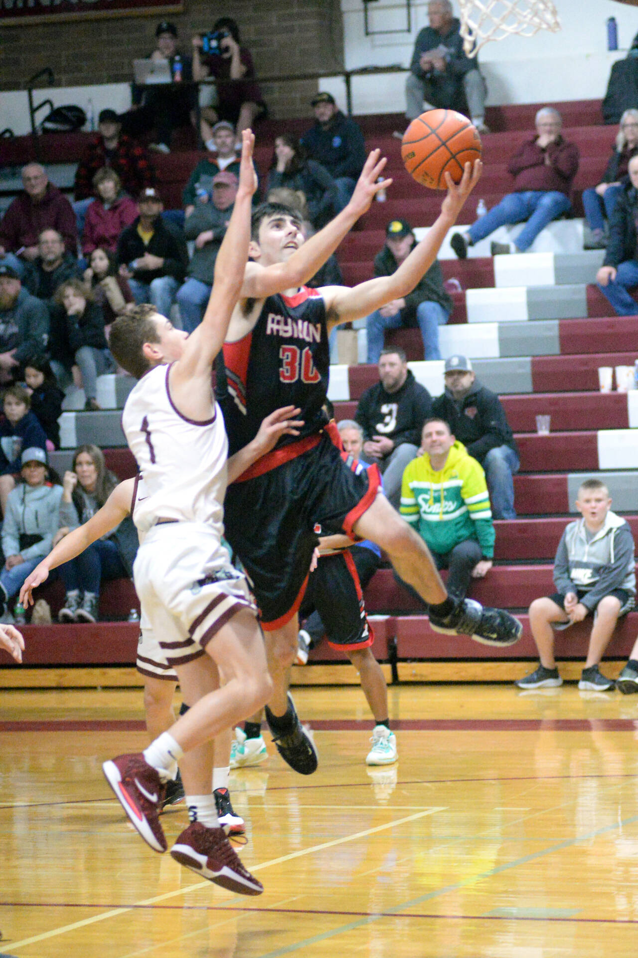 RYAN SPARKS | THE DAILY WORLD Raymond senior guard Morgan Anderson (30) scores on a layup while Montesano’s Terek Gunter defends during the Seagulls’ 60-47 victory on Wednesday at Montesano High School. Anderson scored 23 points to lead the Seagulls.