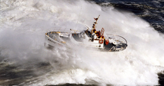 Larry Kellis / USCG 
A U.S. Coast Guard 52-foot Motor Lifeboat crashes through a wave in the Pacific Ocean. The services is currently weighing how to replaces the vessels, which were in service for nearly 60 years.