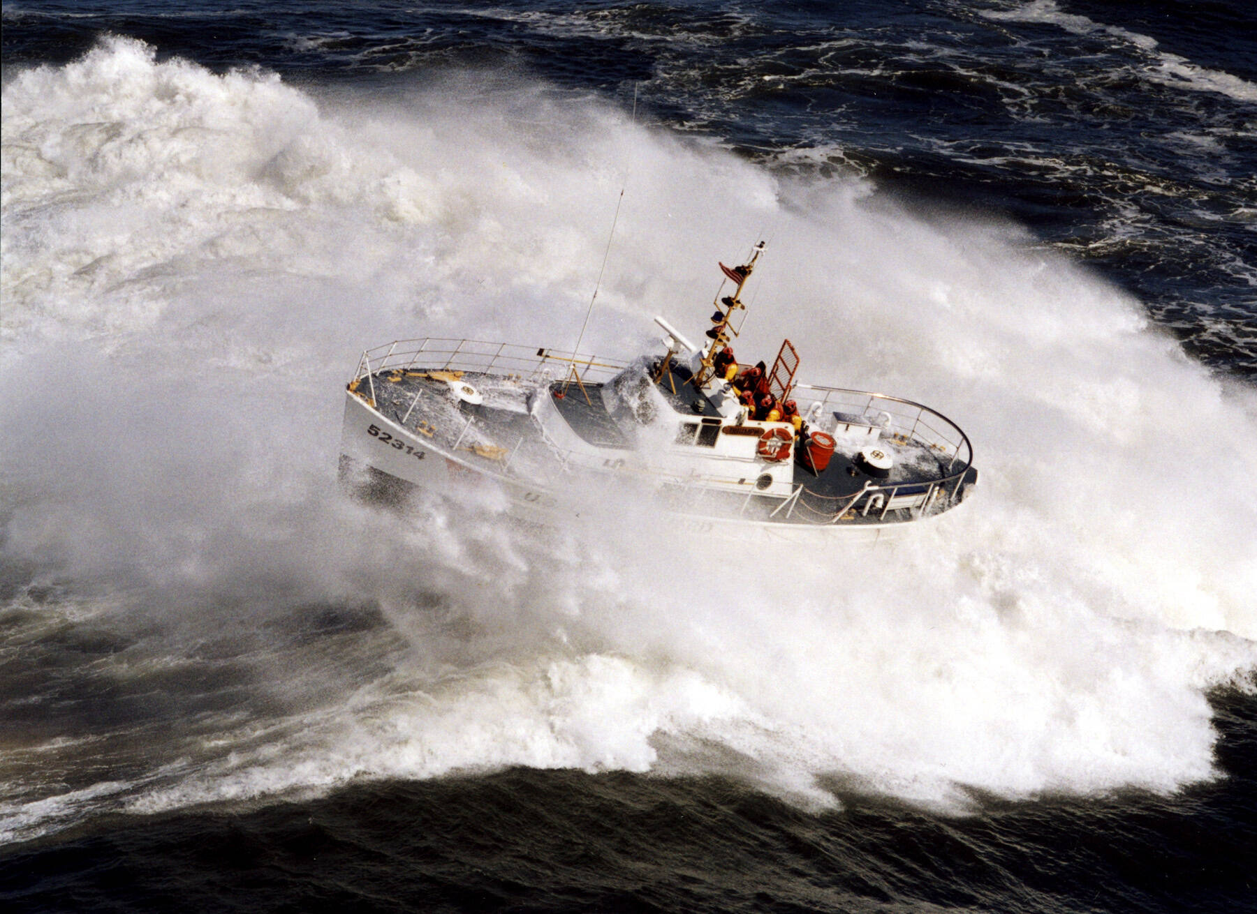 A U.S. Coast Guard 52-foot Motor Lifeboat crashed through a wave in the Pacific Ocean. The services is currently weighing how to replaces the vessels, which were in service for nearly 60 years. (Larry Kellis / USCG)