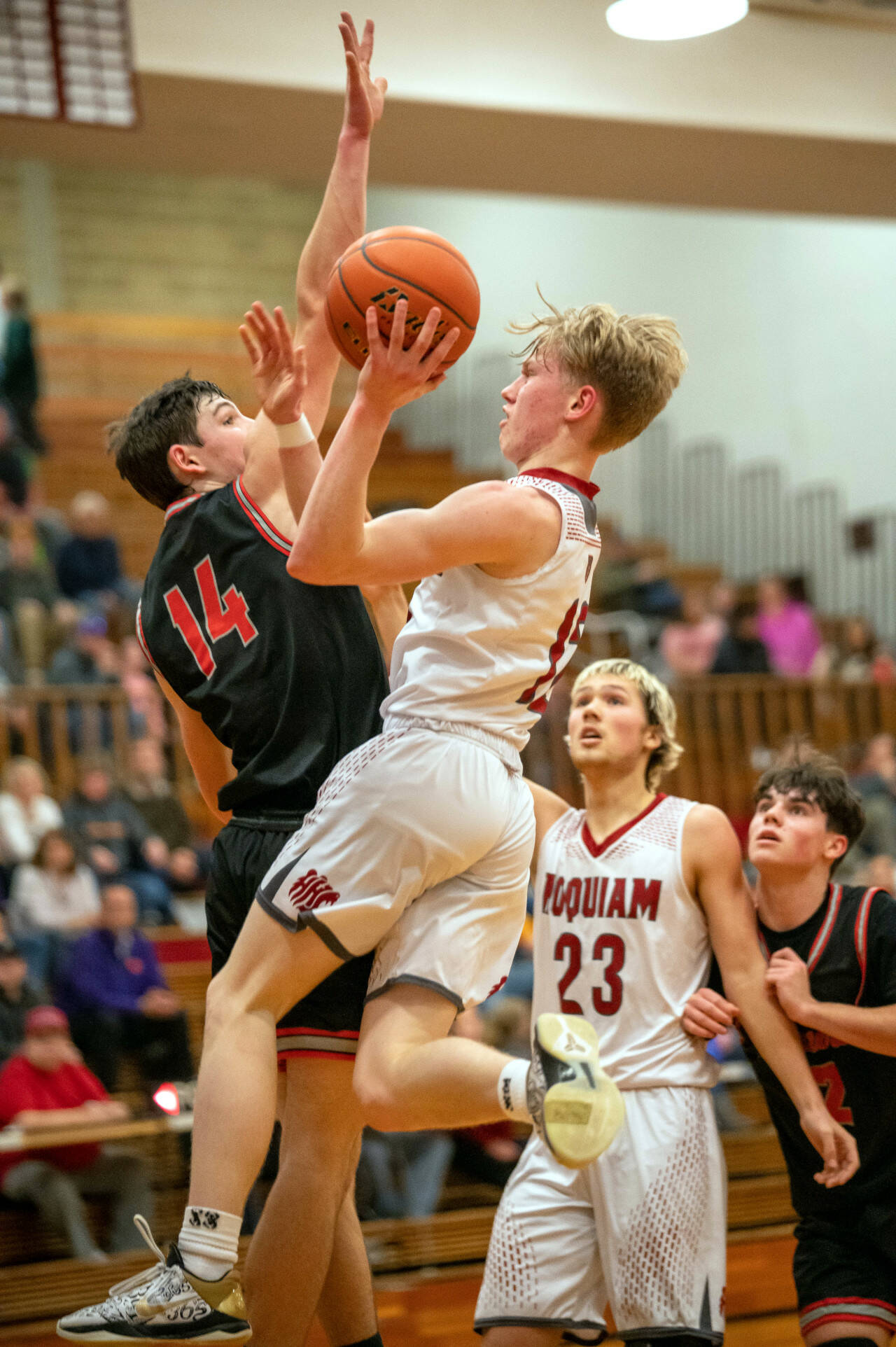 PHOTO BY FOREST WORGUM Hoquiam guard Michael Lorton Watkins glides to the hoop while being defended by Tenino’s Brody Noonan (14) during the Grizzlies’ 62-47 loss on Friday in Hoquiam.
