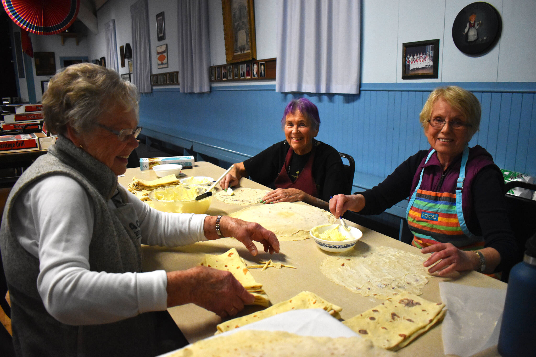 Haldis Totland, Jane Louzan and Ella Seely, from left to right, slather creamy butter onto the Lefse before folding it. While they worked, they happily shared stories, talked about the societal difficulties upon immigrating to the United States and called for more butter when they ran out. Dixie Thompson, lodge president of the Sons of Norway Grays Harbor, championed Totland and Seely’s skillset in making Lefse. “Ella and Haldis are both from Norway and they know how to do everything,” Thompson said. (Matthew N. Wells / The Daily World)(Matthew N. Wells / The Daily World)