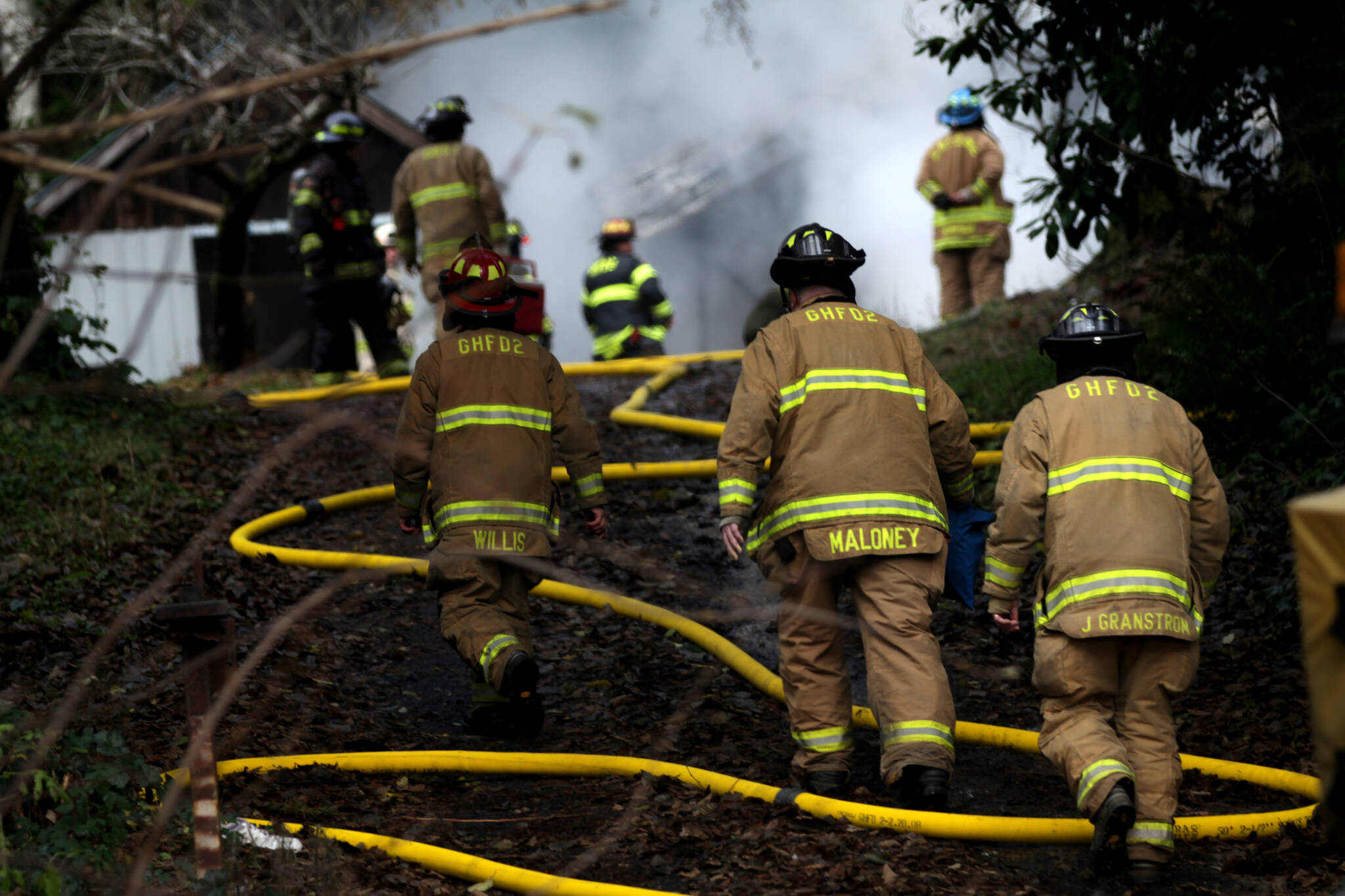 Firefighters climb towards a structure fire that broke out on Dec. 13, 2022 outside of Aberdeen. (Michael S. Lockett / The Daily World File)