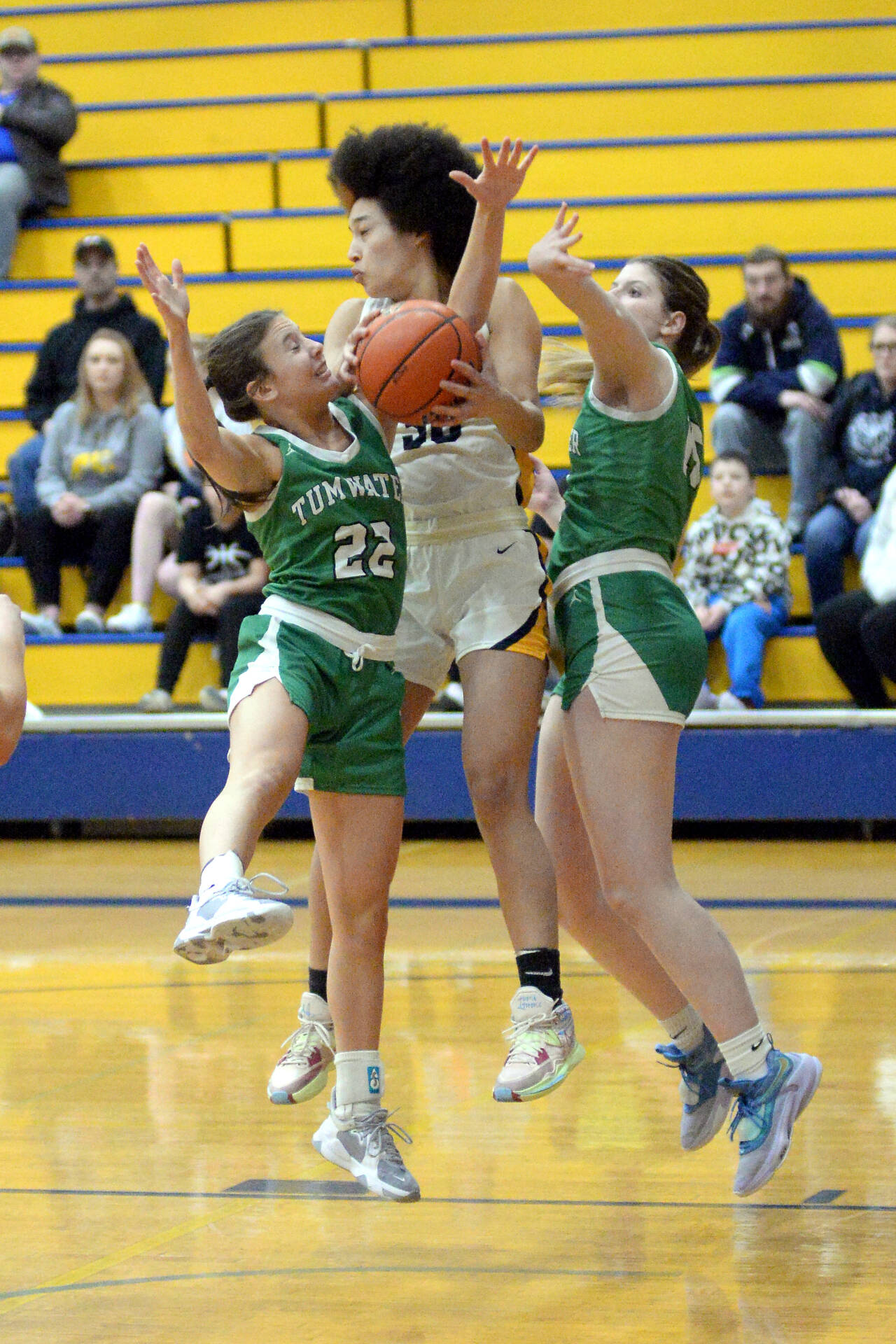 RYAN SPARKS | THE DAILY WORLD Aberdeen senior guard Maddie Gore (30) is fouled while grabbing a rebound against Tumwater’s Regan Brewer (22) and Kendall Gjurasic during the Bobcats’ 65-32 loss on Friday at Sam Benn Gym in Aberdeen.