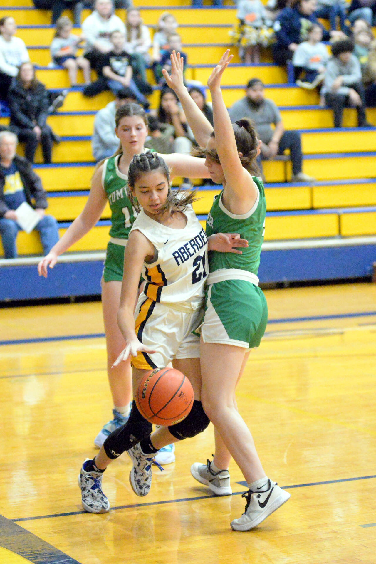 RYAN SPARKS | THE DAILY WORLD Aberdeen junior Jaylynn Phimmasone (21) looks to dribble around Tumwater’s Morgan Simmons during the Bobcats’ 65-32 loss on Friday at Sam Benn Gym in Aberdeen.