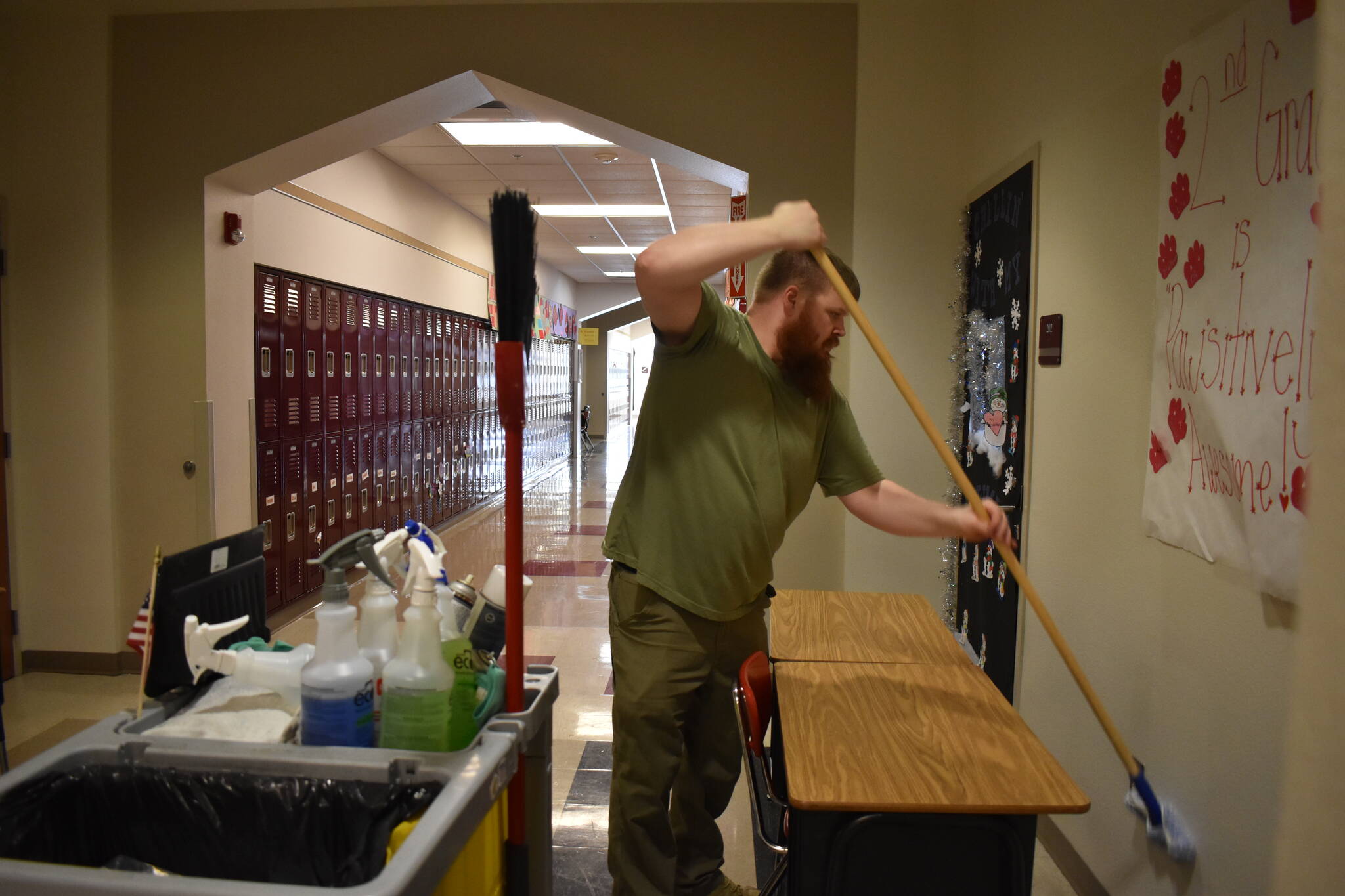 Clayton Franke / The Daily World 
Brandon Hobgood, an evening custodian with the North Beach School District, swabs hydrogen peroxide on the walls at Ocean Shores Elementary School Tuesday afternoon.