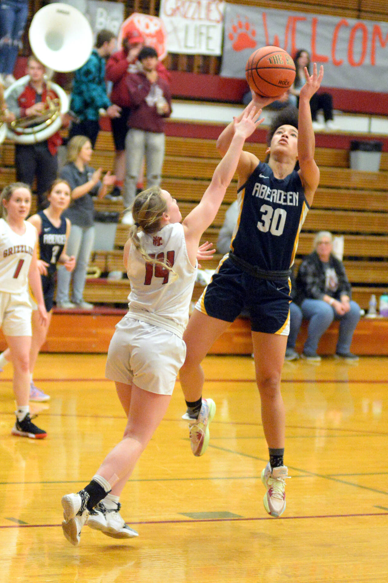 RYAN SPARKS | THE DAILY WORLD Aberdeen guard Maddie Gore (30) pulls up for a jump shot while defended by Hoquiam’s Ella Folkers (14) during the Bobcats’ 52-44 win on Thursday in Hoquiam.
