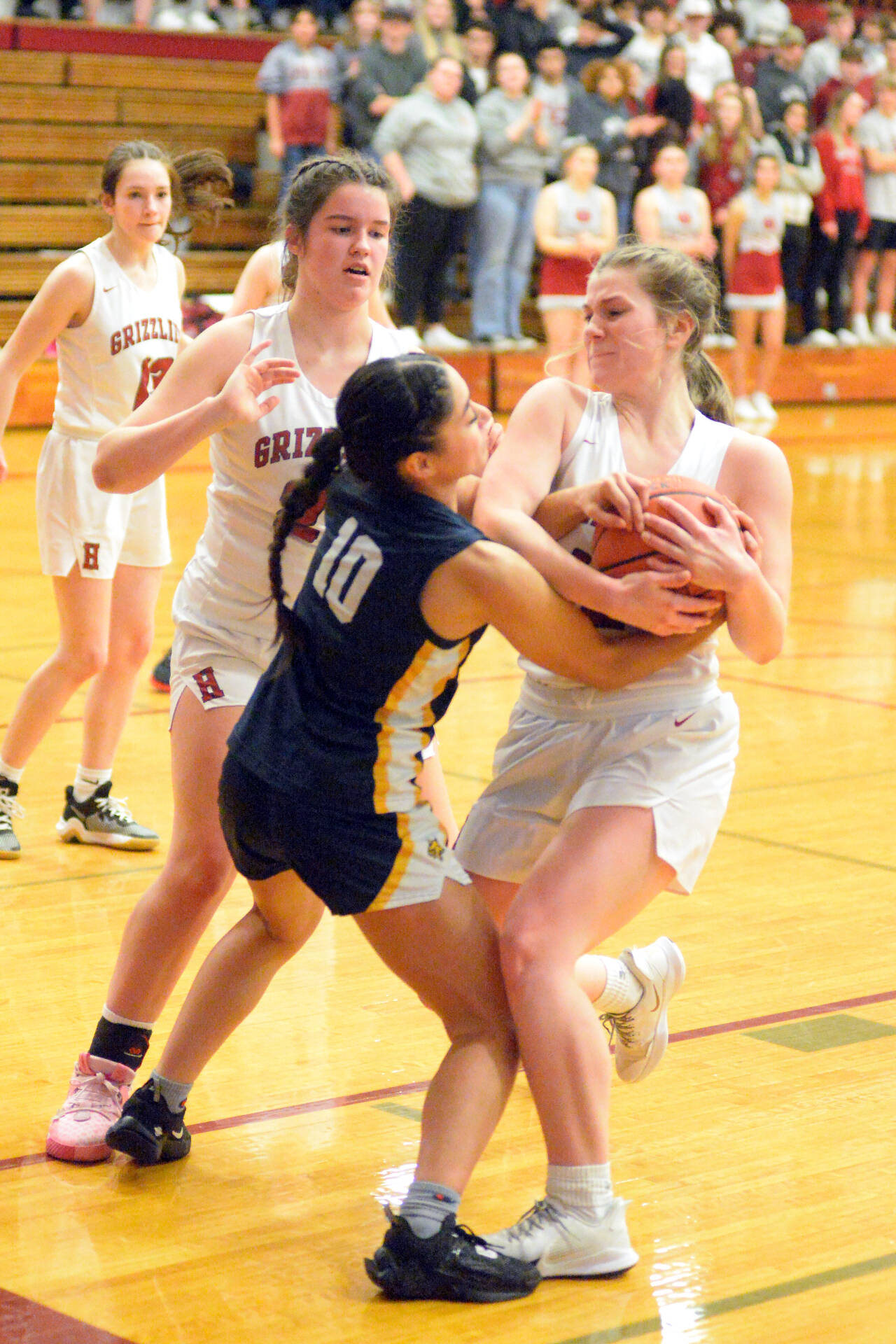 RYAN SPARKS | THE DAILY WORLD Hoquiam’s Ashlinn Cady, right, wrestles with Aberdeen’s Marina Marll (10) for possession during the Bobcats’ 52-44 win on Thursday in Hoquiam.