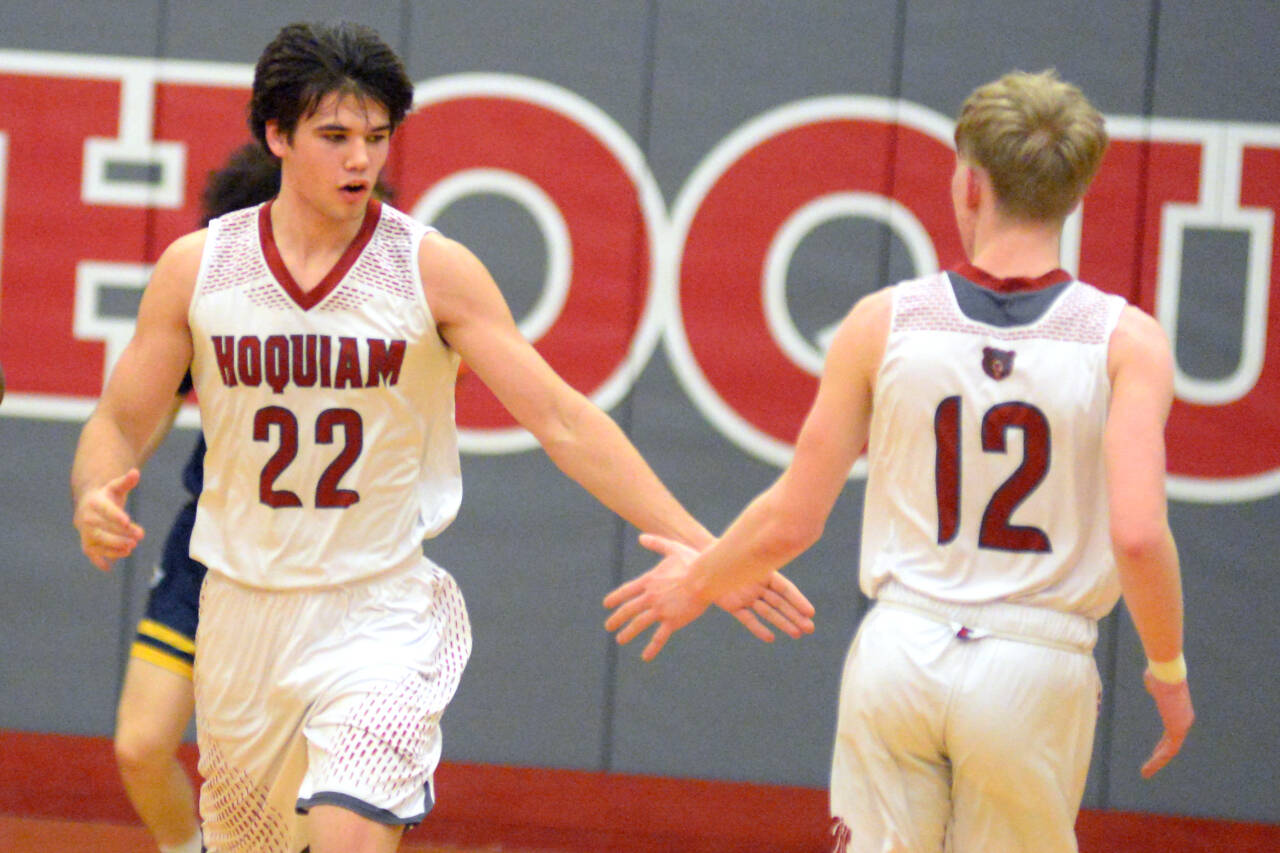 RYAN SPARKS | THE DAILY WORLD Hoquiam’s Aiden Butcher (22) low-fives teammate Micheal Lorton Watkins during the first half of the Grizzlies’ 67-38 victory over Aberdeen on Friday in Hoquiam.