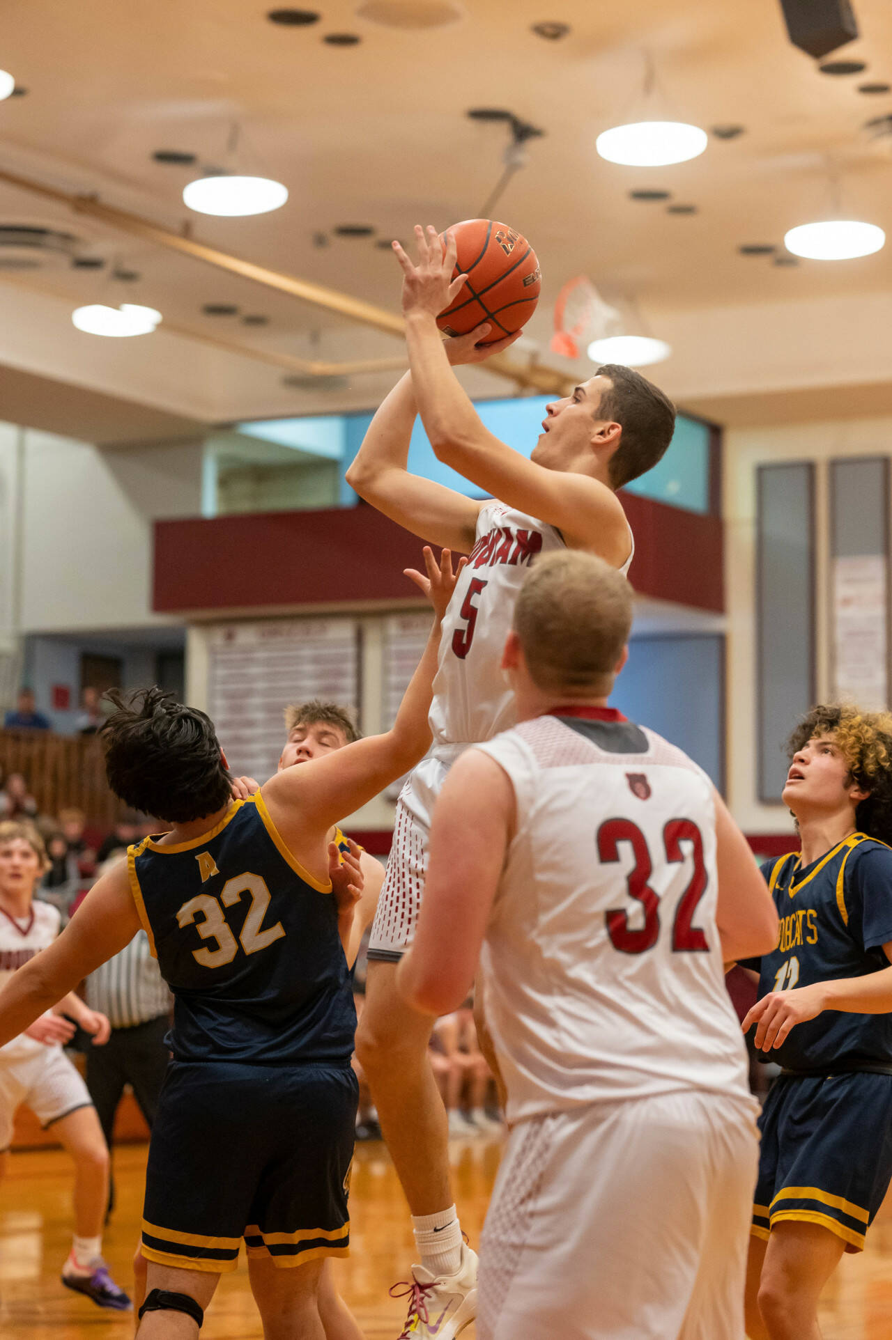 PHOTO BY FOREST WORGUM Hoquiam’s Owen McNeill (5) puts up a jump shot over Aberdeen’s Kenny Dawson, left, during the Grizzlies’ 67-38 win on Friday at Hoquiam High School.