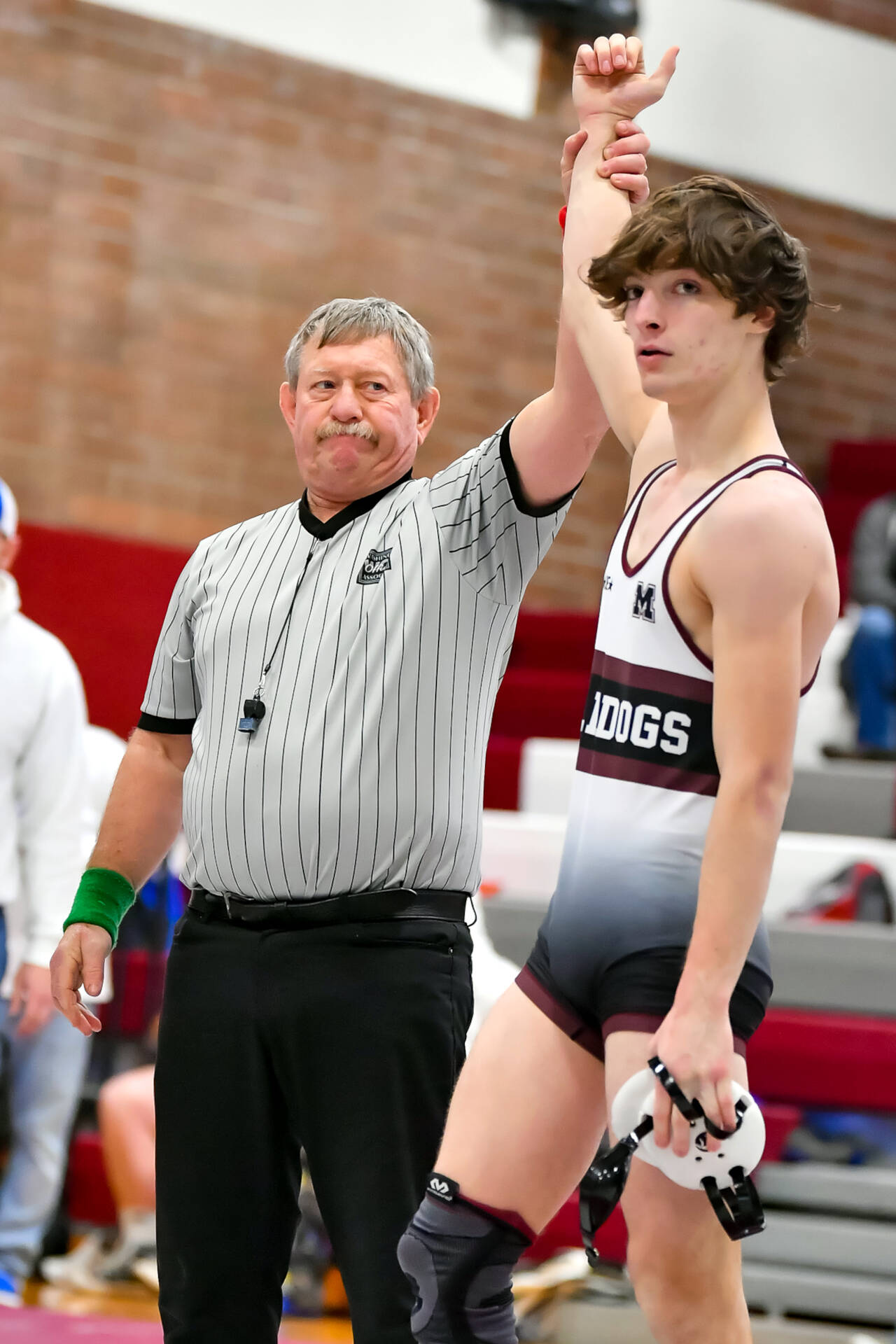 JIM THRALL | MATFOCUS.COM A familiar sight for Montesano wrestling fans, Bulldogs senior Cole Ekerson has his hand raised after winning a match at a 1A Evergreen League duals meet on Saturday in Montesano. Ekerson would record his 100th victory at the meet.