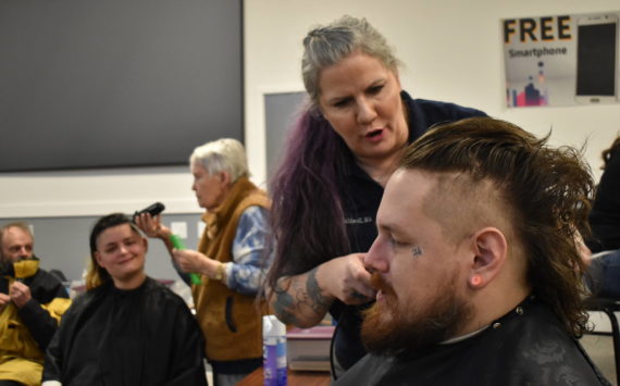 Clayton Franke / The Daily World 
Rose Warne, second from left, and her husband, Skyler Warne, front right, receive haircuts from Pat Gordon and Laina Caldwell, respectively, at the Project Homeless Connect Event on Thursday, Jan. 26 at the Aberdeen Senior Center.