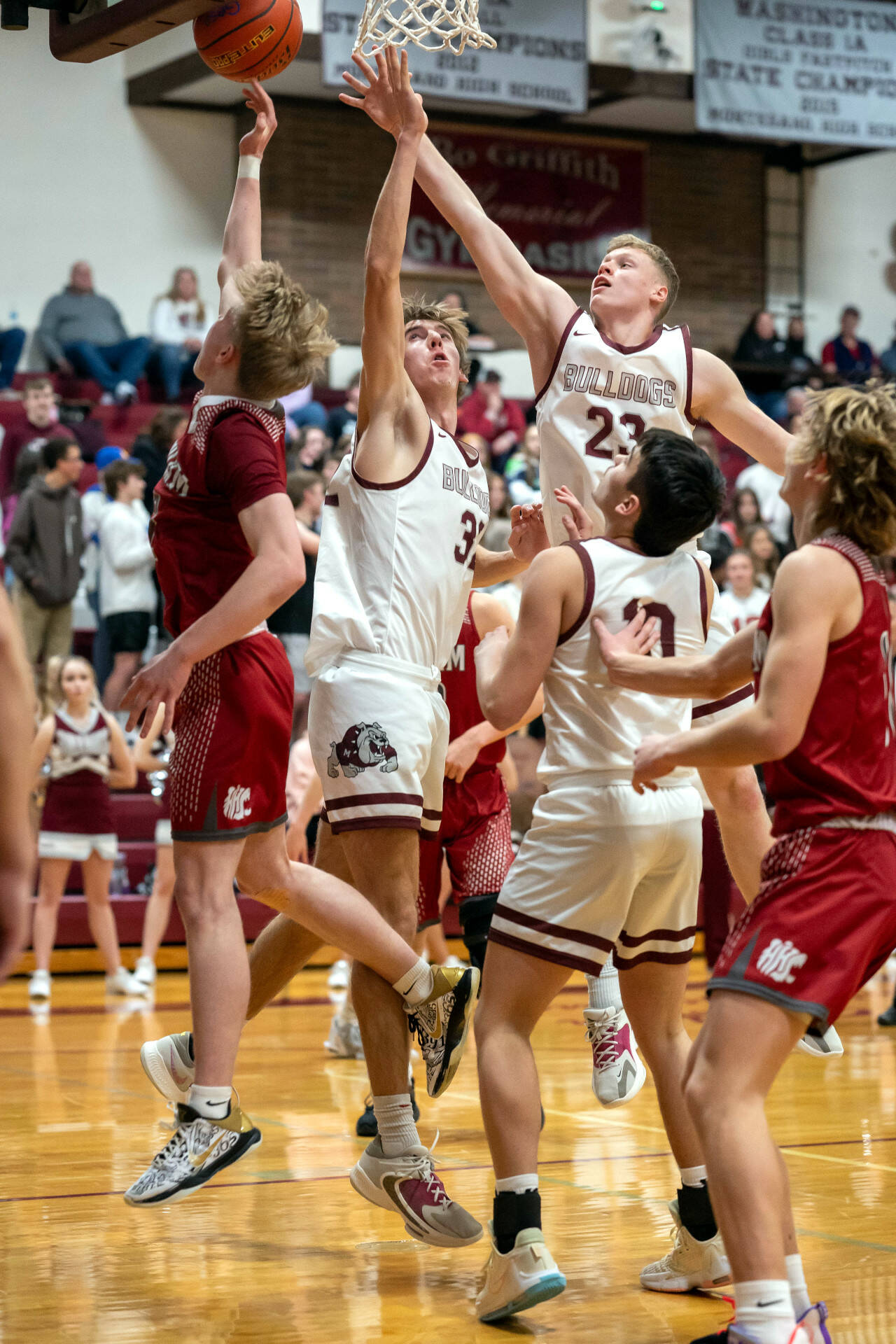 PHOTO BY FOREST WORGUM Montesano’s Tyce Peterson (23) and Soren Cobb defend against Hoquiam’s Michael Lorton Watkins, left, during the Grizzlies’ 54-28 win on Thursday in Montesano.