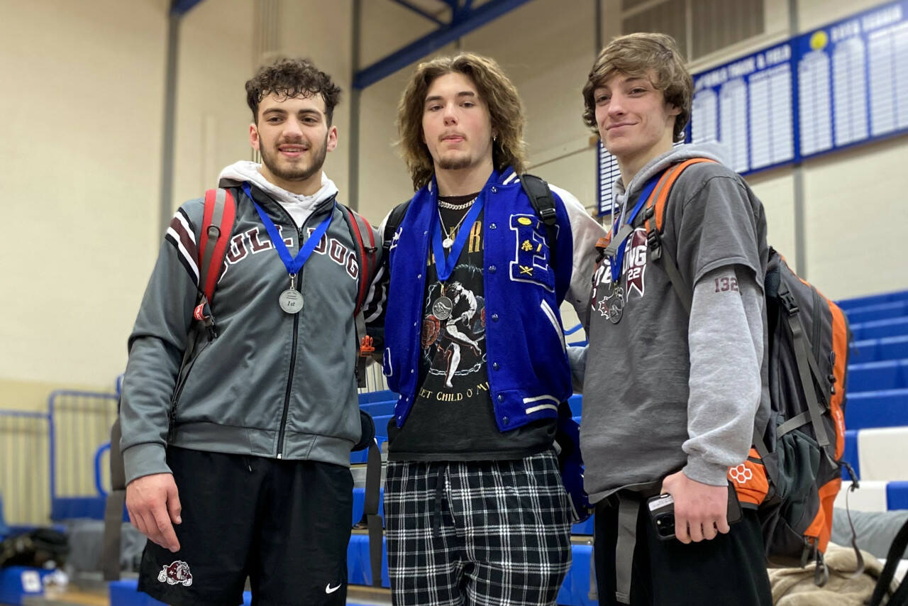 SUBMITTED PHOTO
Montesano wrestlers Mateo Sanchez, left, and Cole Ekerson, right, flank Elma’s Austin Salazar at the conclusion of the 1A Evergreen sub-district meet on Saturday at Eatonville High School. The three Harbor student-athletes were named co-Outstanding Wrestlers for the league.