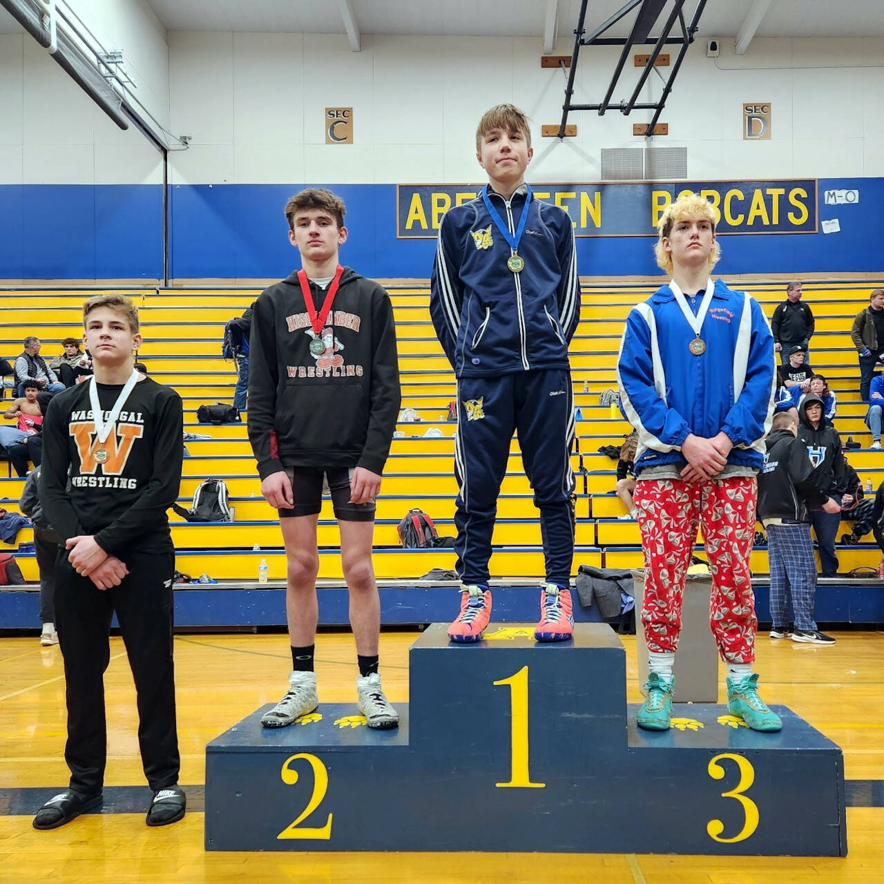 SUBMITTED PHOTO Aberdeen’s Mikey Hatton (1) stands atop the podium after winning the 126-pound championship at the 2A Region 3 Championships on Saturday in Aberdeen.