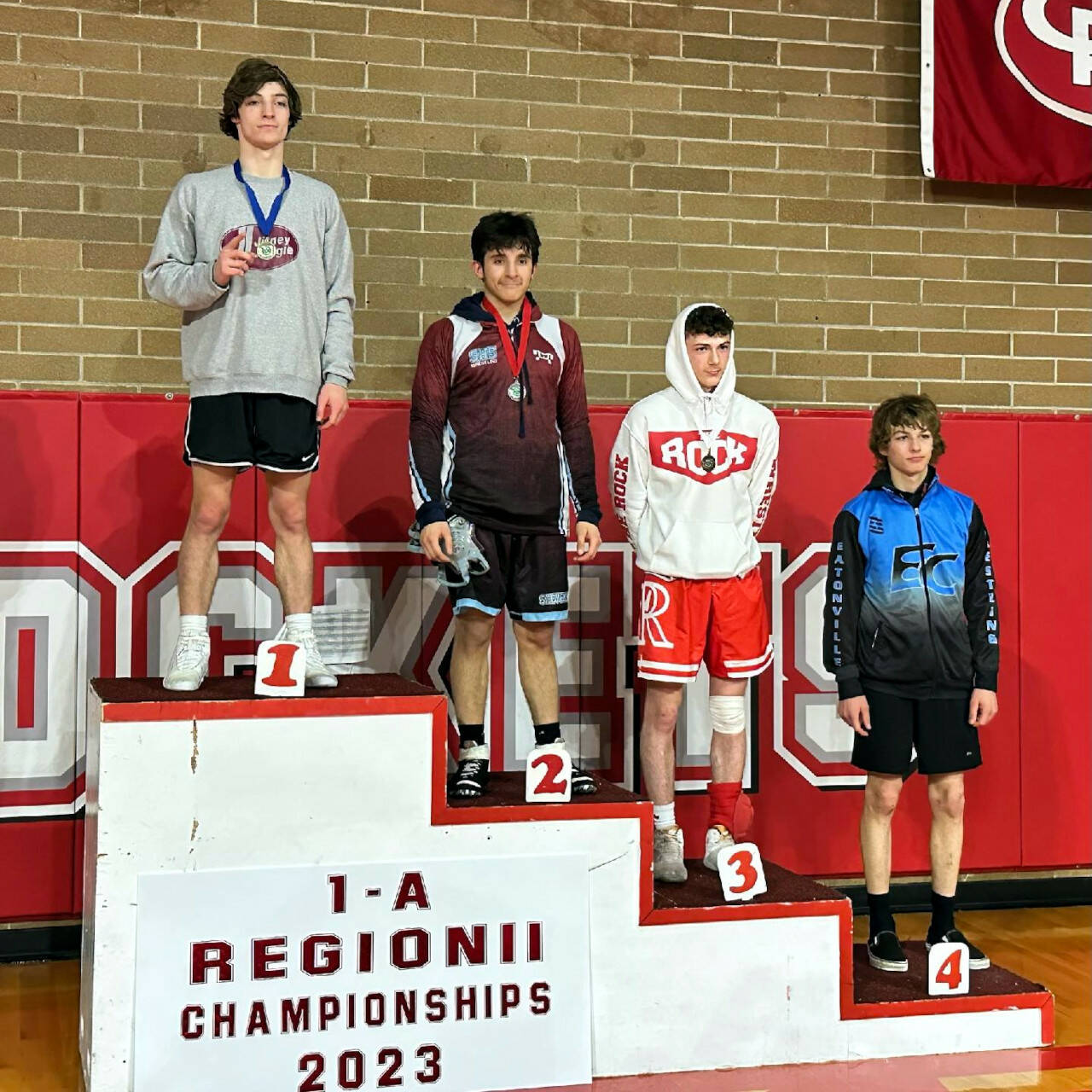 SUBMITTED PHOTO
Montesano’s Cole Ekerson, left, stands atop the podium after winning the 132-pound title at the 1A Region 3 Championships on Saturday at Castle Rock High School.