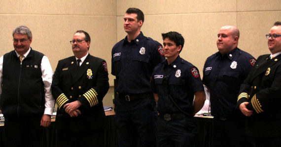 Michael S. Lockett / The Daily World 
New joins to the Ocean Shores Fire Department stand alongside officers of the department and Ocean Shores Mayor Jon Martin, left, during a swearing-in ceremony on Feb. 13.
