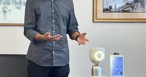 (Courtesy of Michelle Fogus) Adam Seri-Levi of Intuition Robotics delivers a presentation in Pacific County last year about ElliQ, an artificial intelligence companion, which sits on the table.