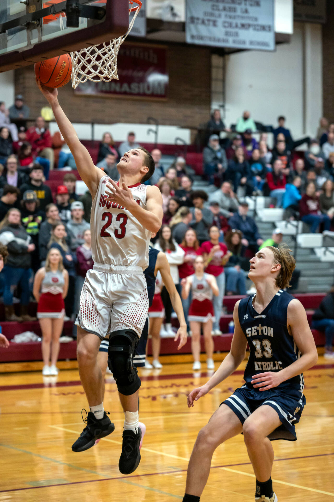 PHOTO BY FOREST WORGUM Hoquiam senior forward Justice Stankavich (23) gets past Seton Catholic’s Jack Jenniges during a 63-45 season-ending loss in a 1A District 4 Tournament elimination game on Thursday in Montesano.