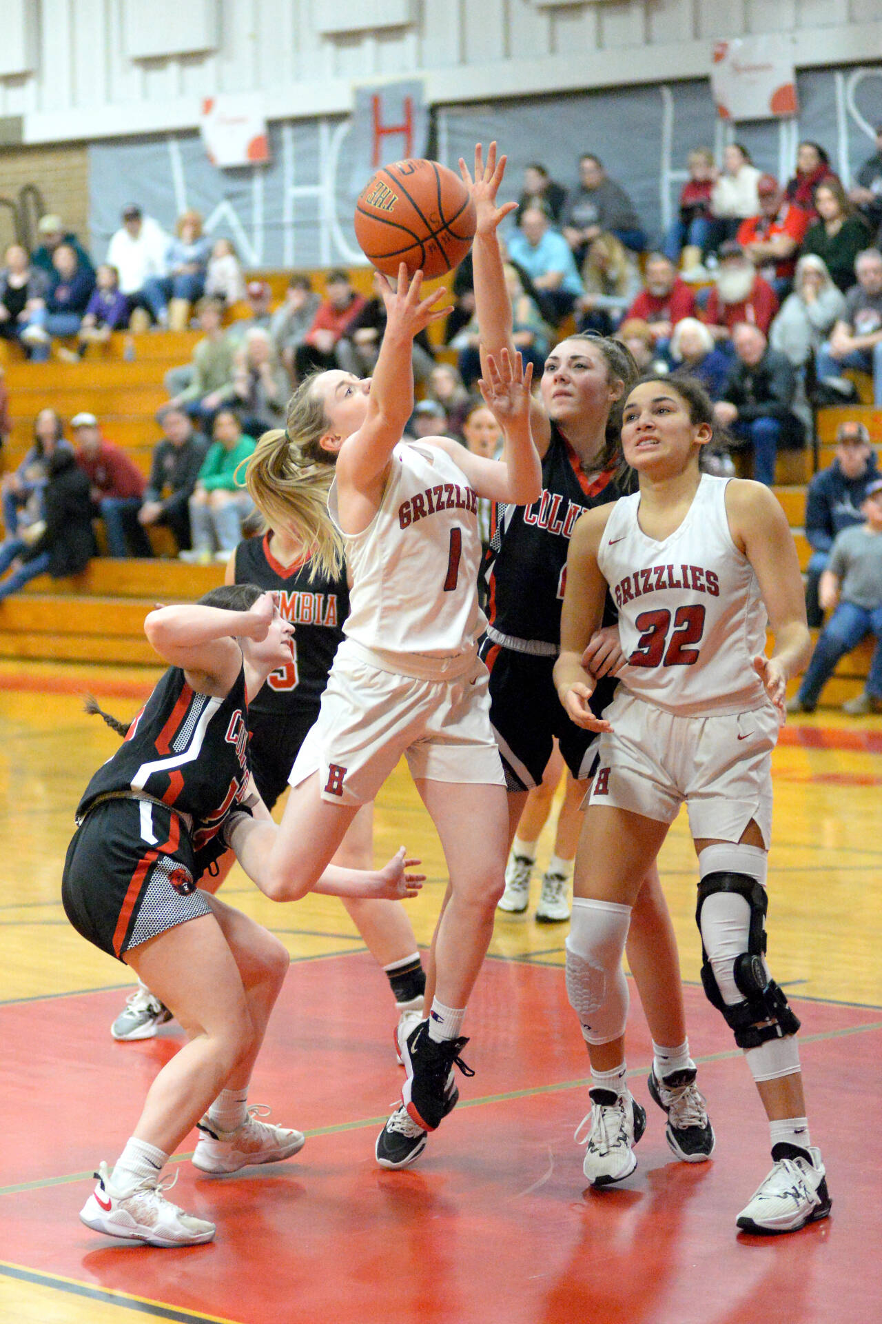RYAN SPARKS | THE DAILY WORLD Hoquiam guard Graci Bonney-Spradlin (1) goes up for a shot as center Chloe Kennedy (32) looks on in a 1A District 4 third-place game against Columbia-White Salmon on Friday in Castle Rock. Hoquiam won 52-44 in overtime to punch the program’s first ticket to state since 2013.