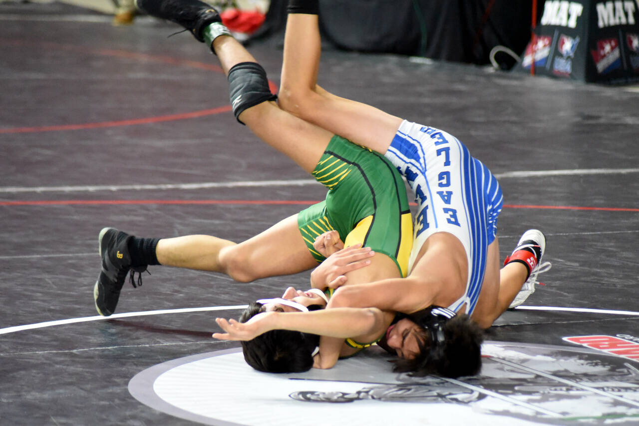 PHOTO BY SUE MICHALAK BUDSBERG Elma freshman Xavier Espinoza, right, looks to pin Quincy’s Saidt Alvarez during a 1A 106-pound semifinal match at the Mat Classic XXXIV state-championship tournament on Saturday at the Tacoma Dome.