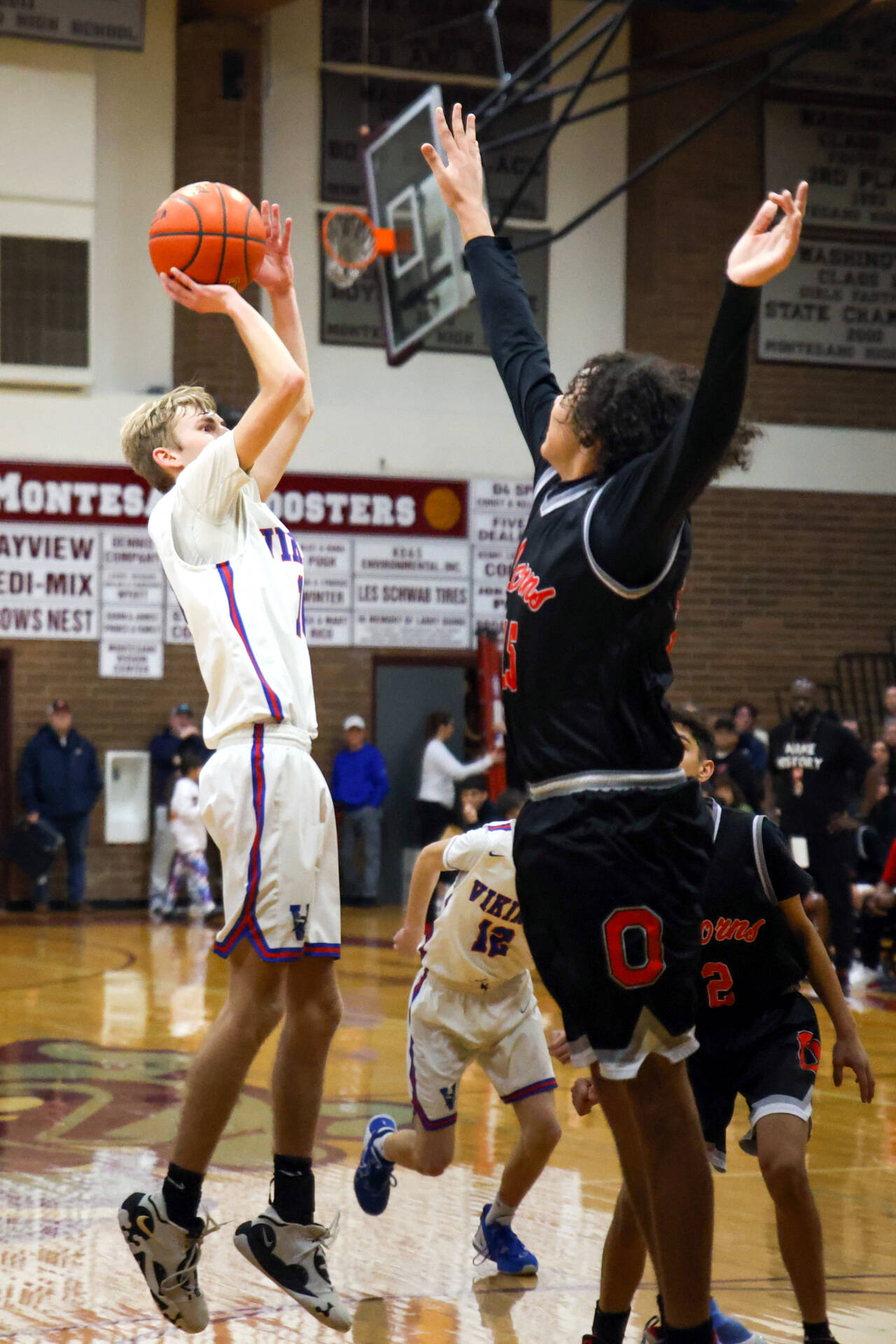 PHOTO BY LARRY BALE Willapa Valley senior Riley Pearson, left, puts up a jump shot during the Vikings’ 62-54 win over Oakville in the 1B District 4 Championship on Saturday at Montesano High School.