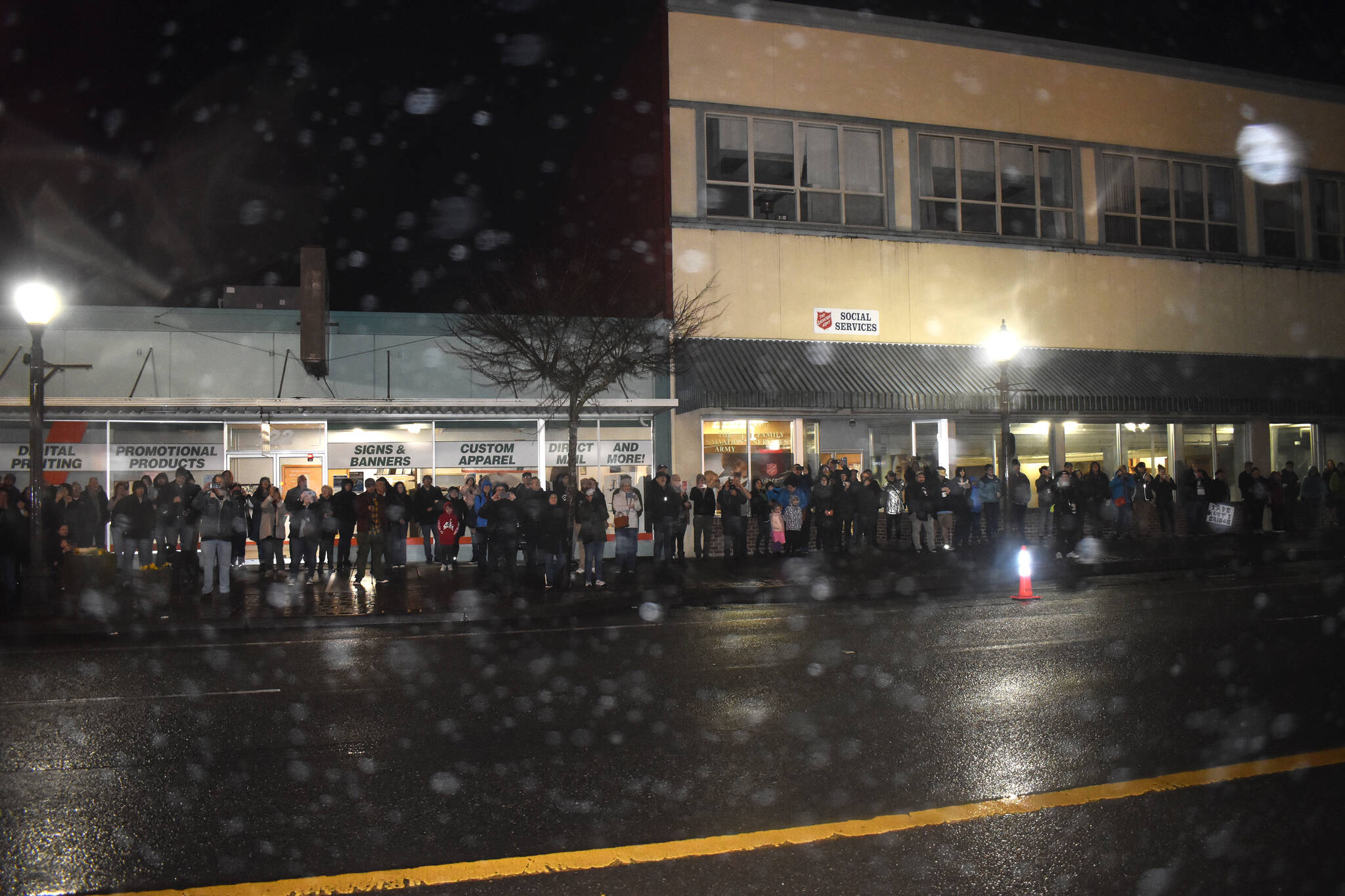 A large crowd — estimated to be at least 200 people — lined the sidewalk between the South K and West Wishkah intersection and the Salvation Army Thrift Store in order to view the lighting of the Side One Building. The building’s owners, with help from Our Aberdeen, hope to bring Nirvana to Aberdeen’s main tourism stage. The attendees, dressed in rain gear and winter jackets because of the wind, rain and cold on Monday night, loved the night’s event. (Matthew N. Wells / The Daily World)